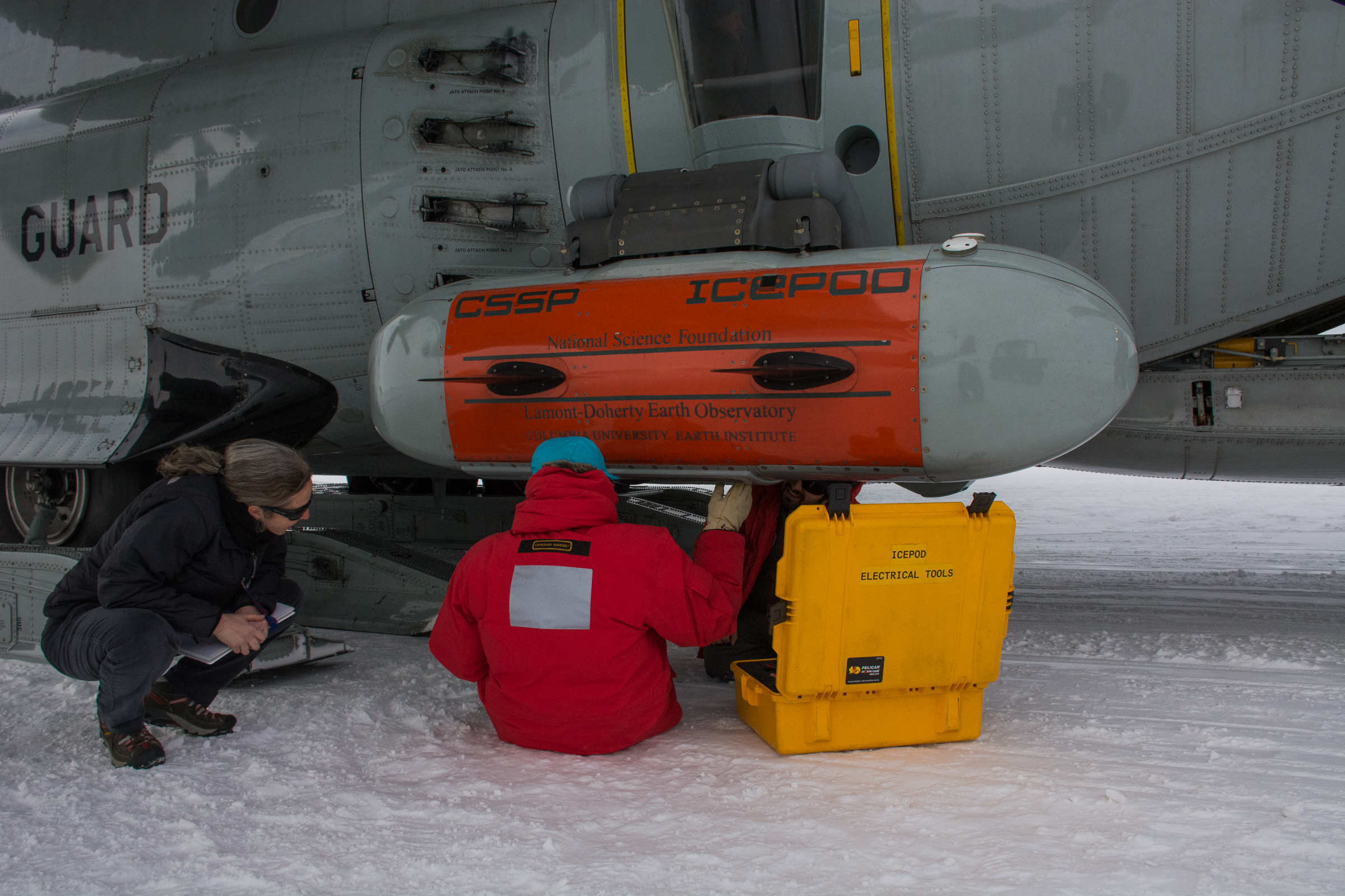Scientists adjust an instrument pod.