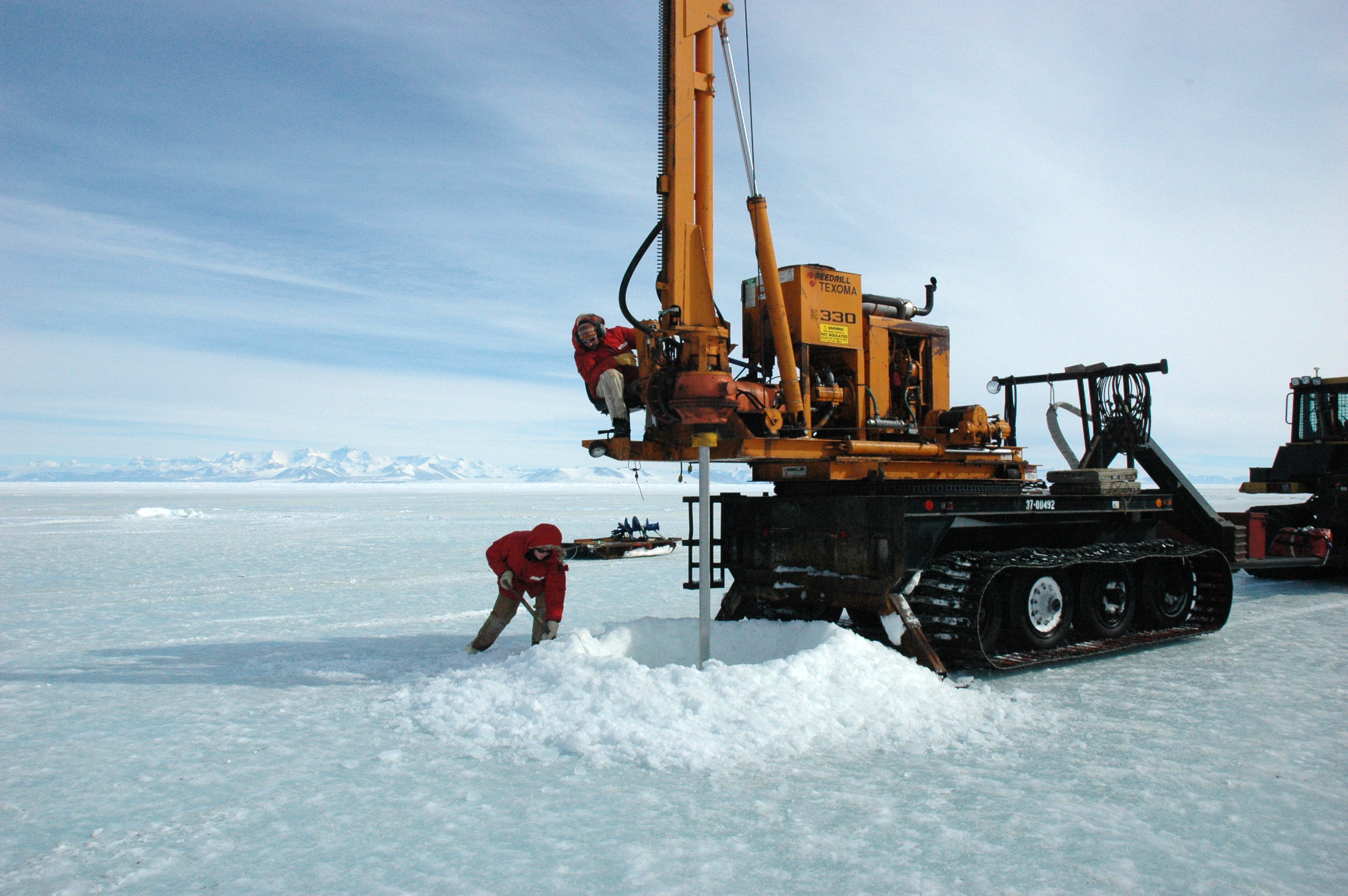 Machine drills hole in ice.