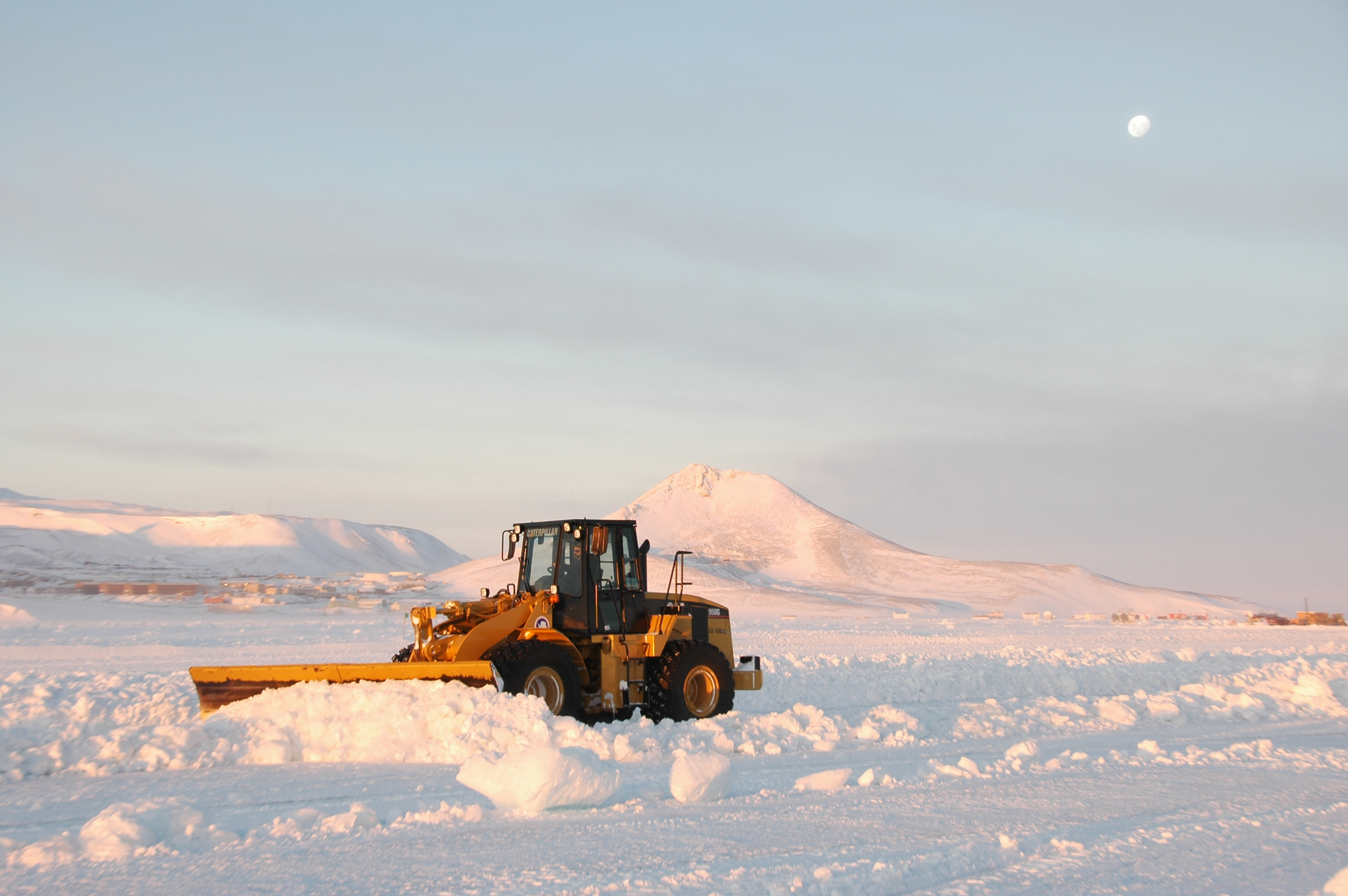 A snowplow pushes snow.