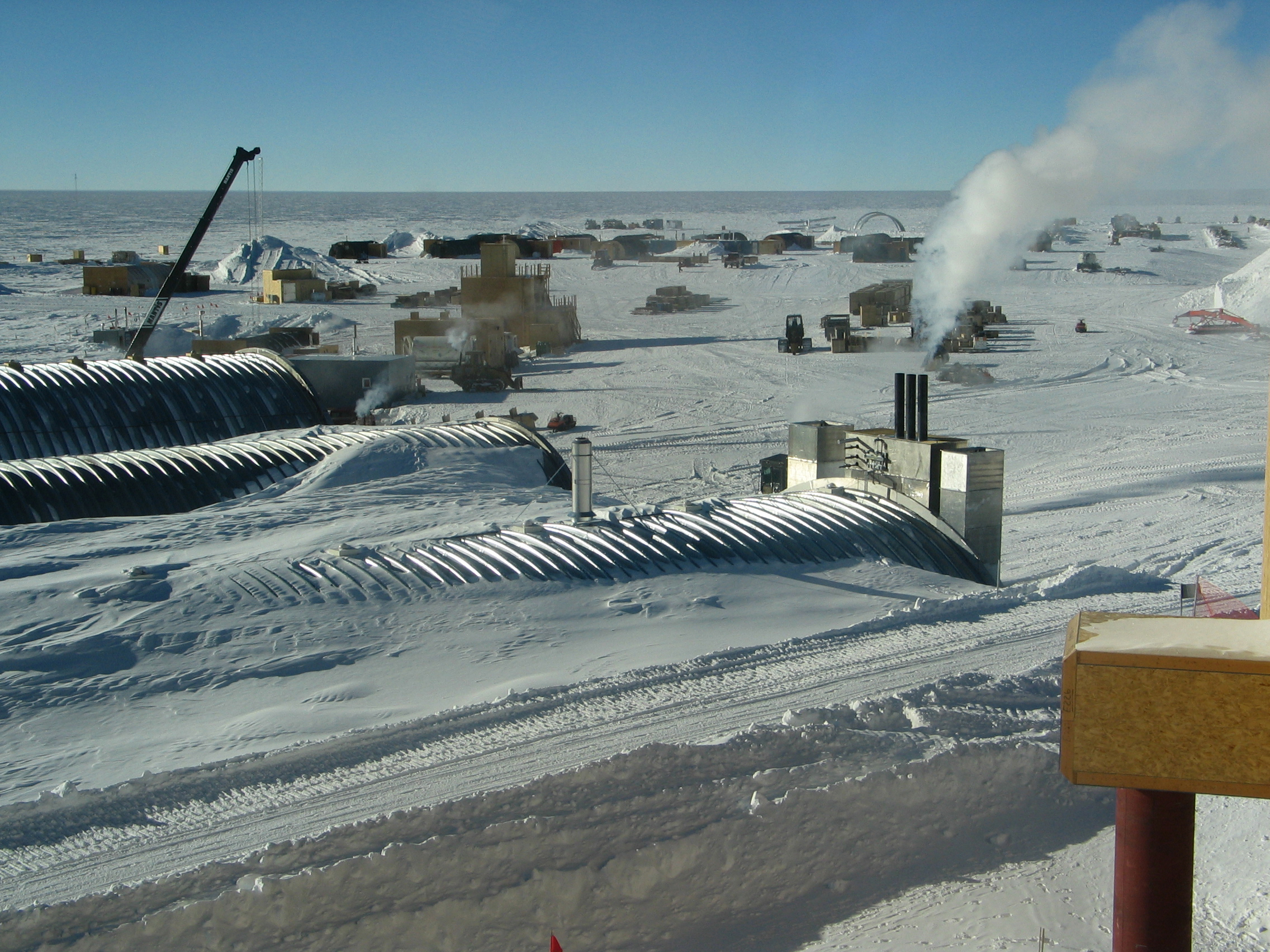 Buildings, cargo and machines on snow.