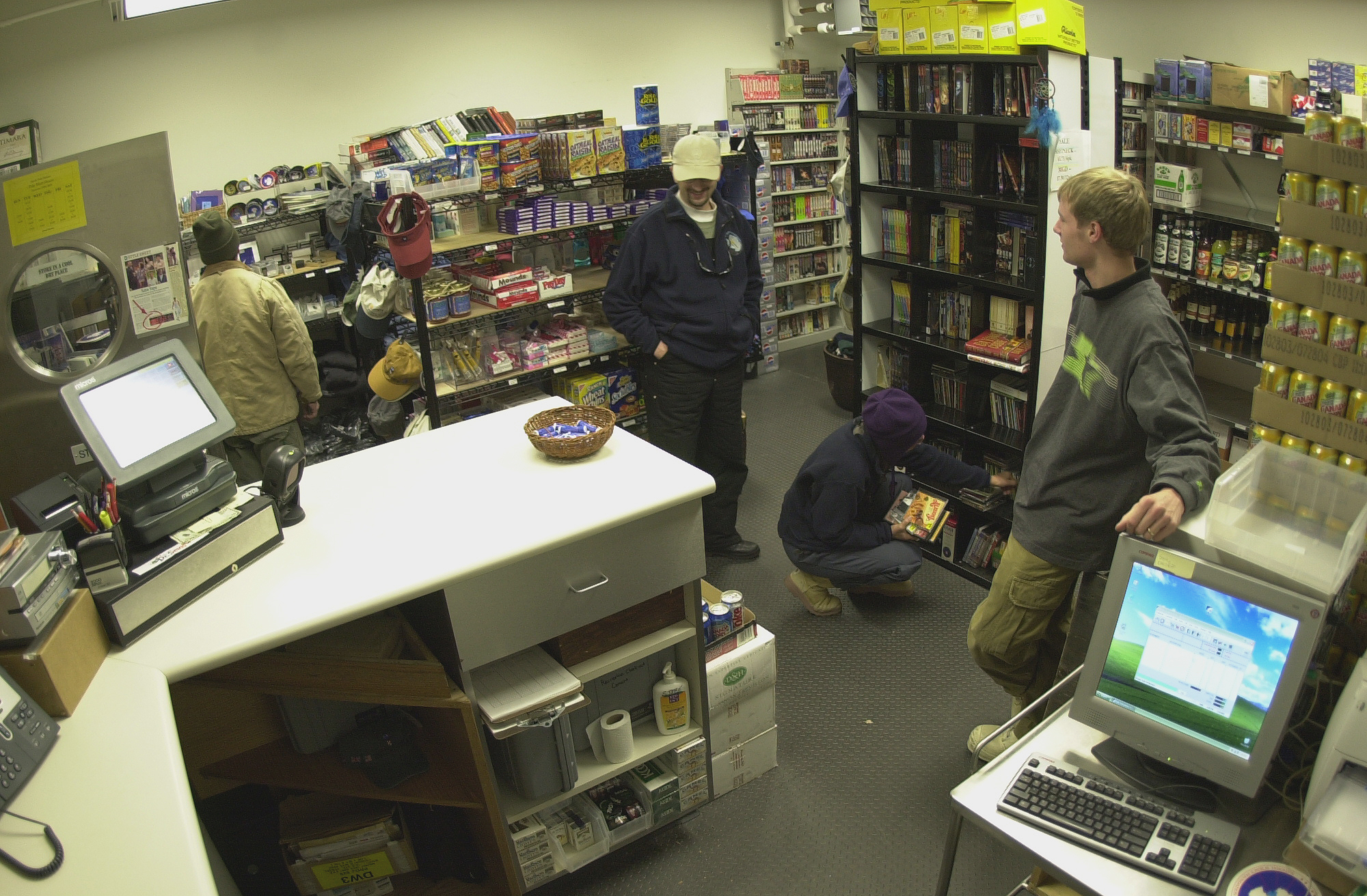 People shopping and talking inside a store.