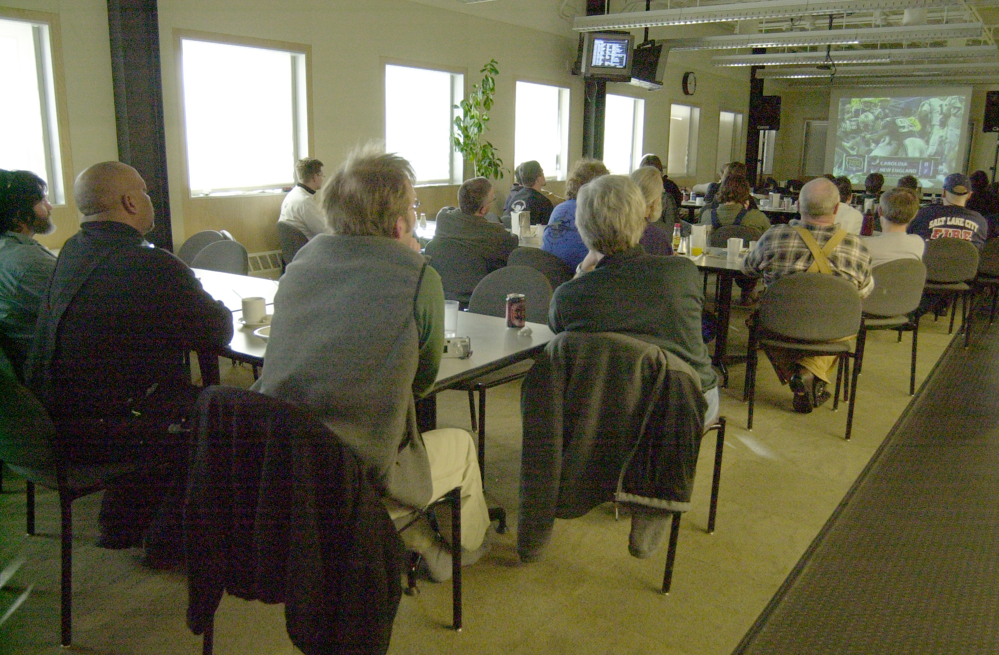 People watching a large screen.