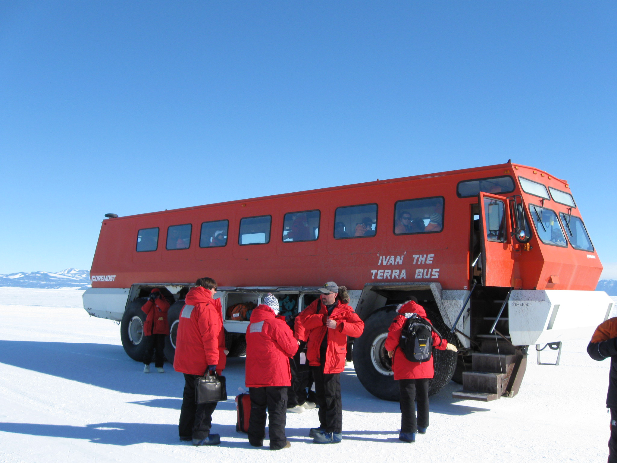 People by a large bus.