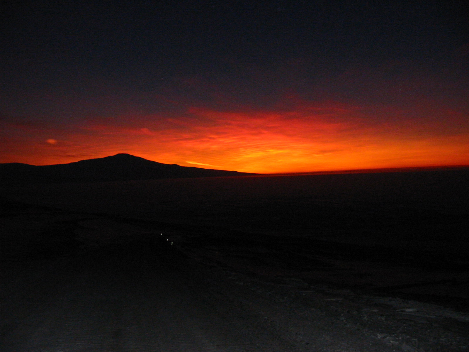 An orange glow in a night sky.