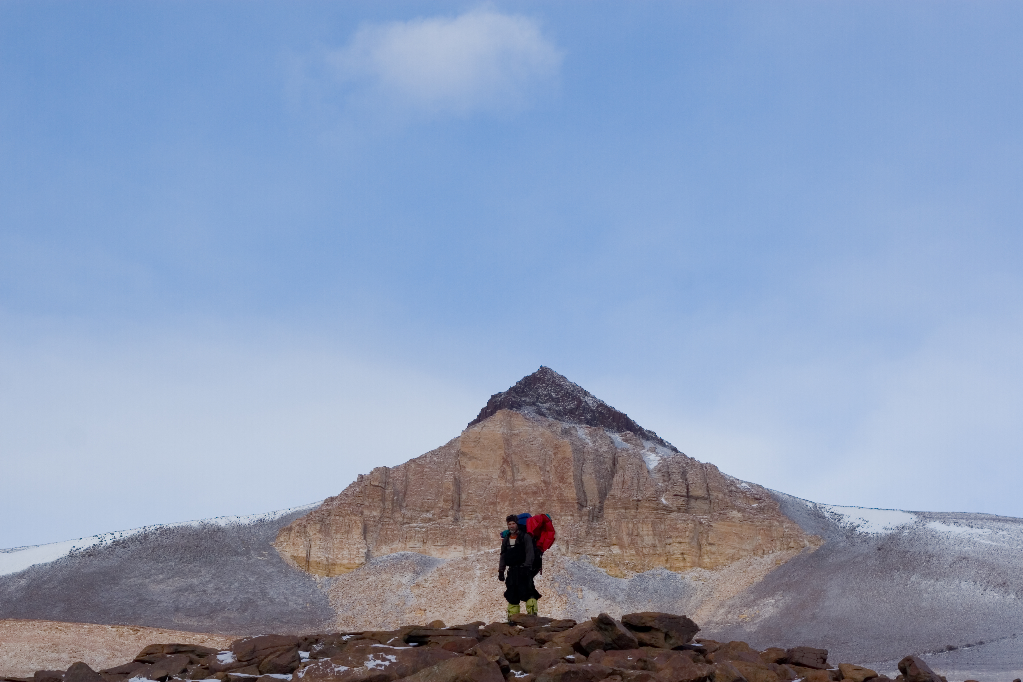 Man hinkes in mountain area.