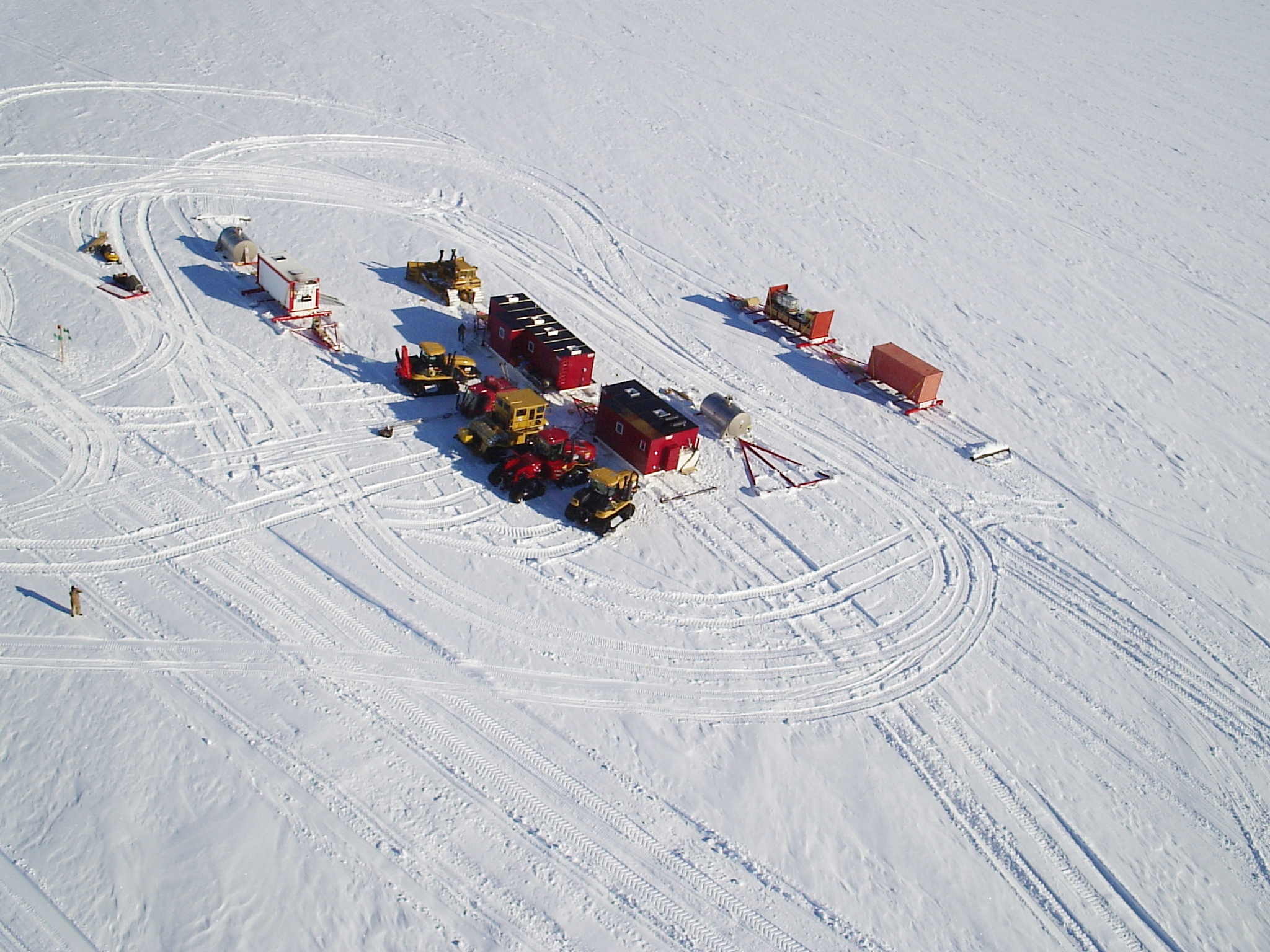 Tractors with sleds on snow.