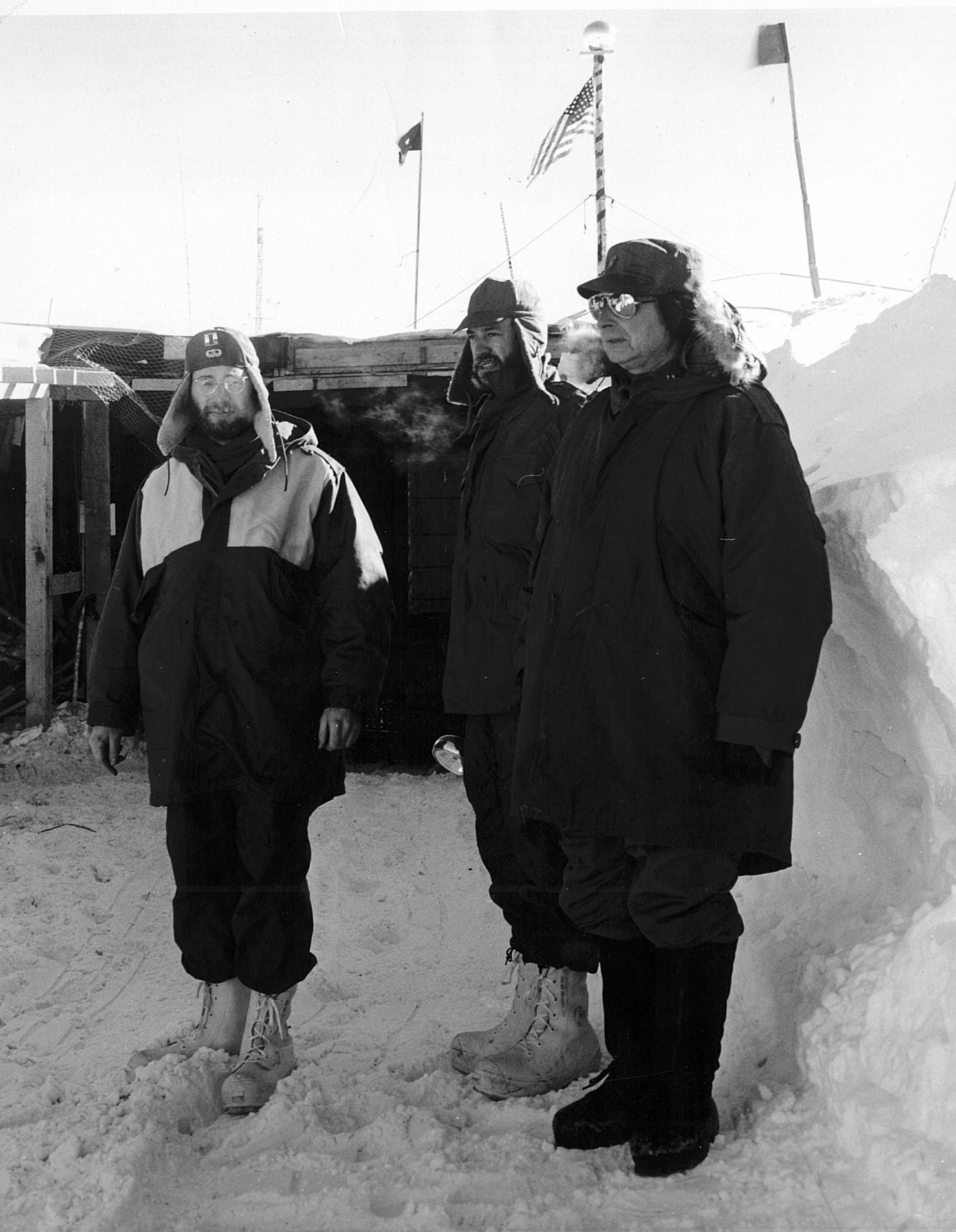 Three men standing outside.