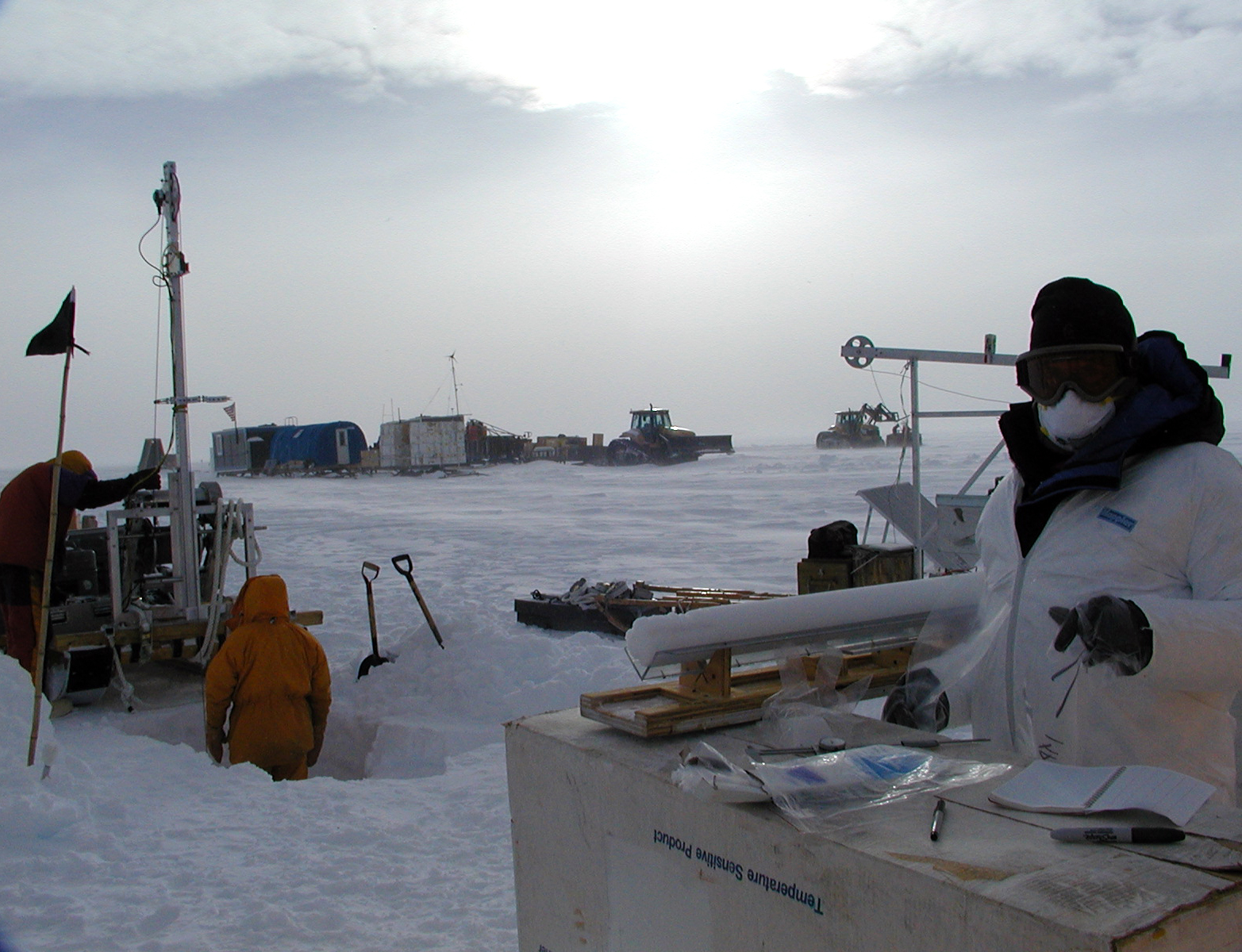 People work outside in snowy place.