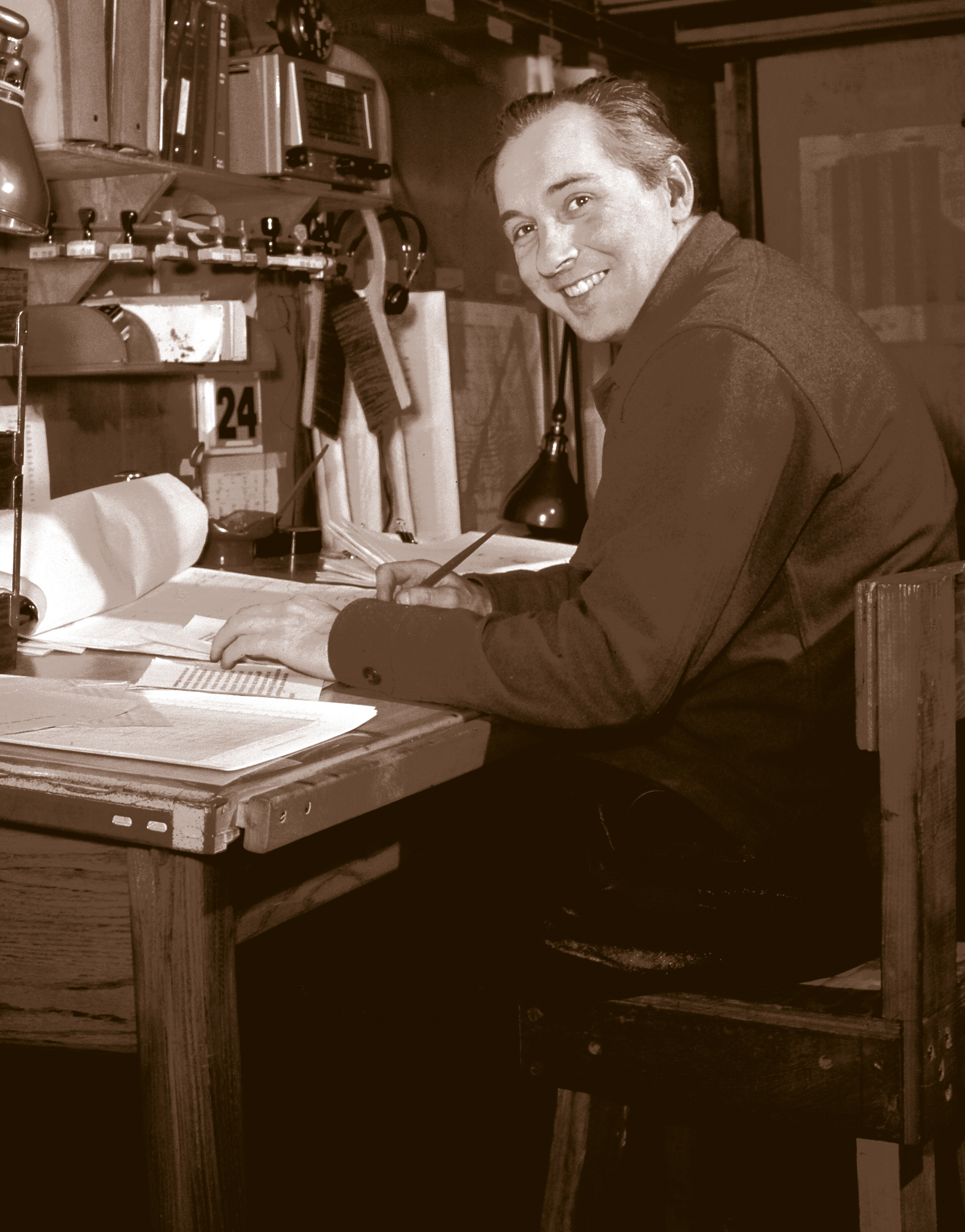 A man sits at a desk.