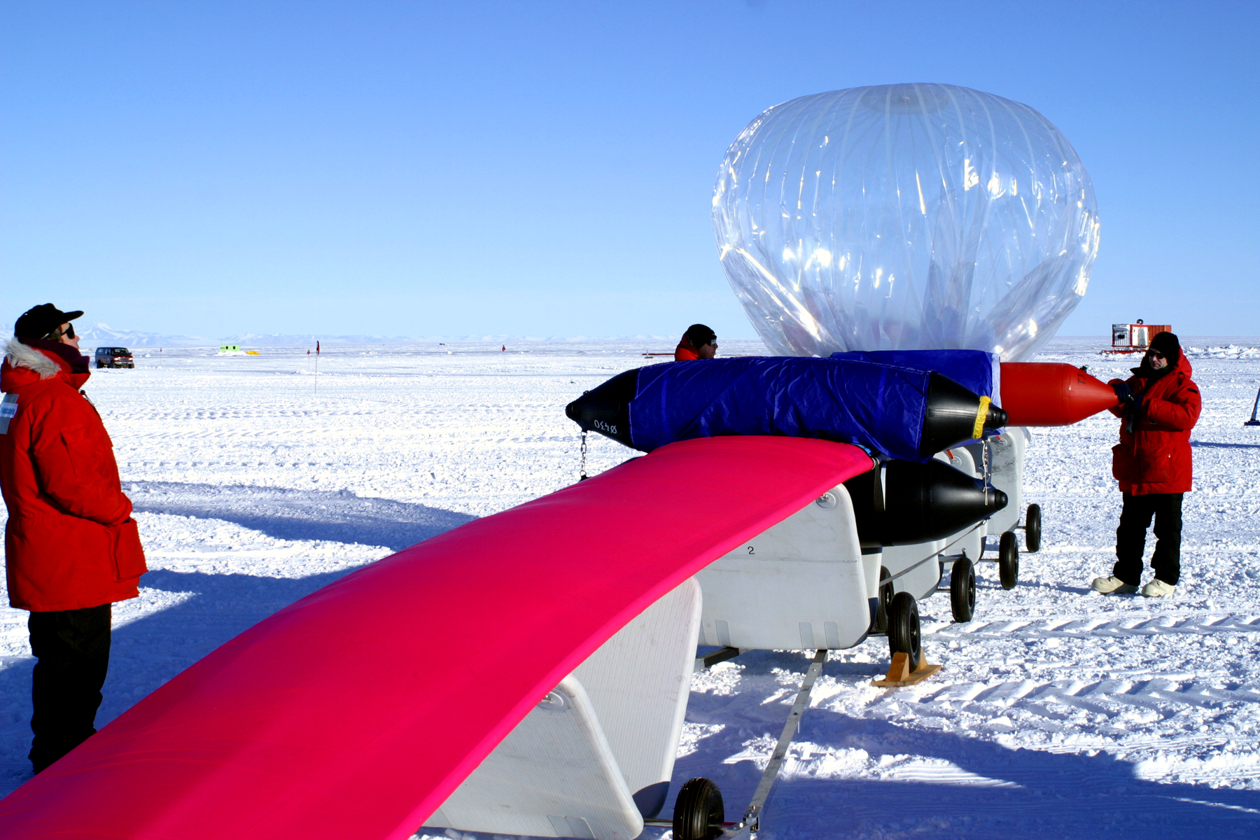 A large, clear balloon sits at the end of a red platform.