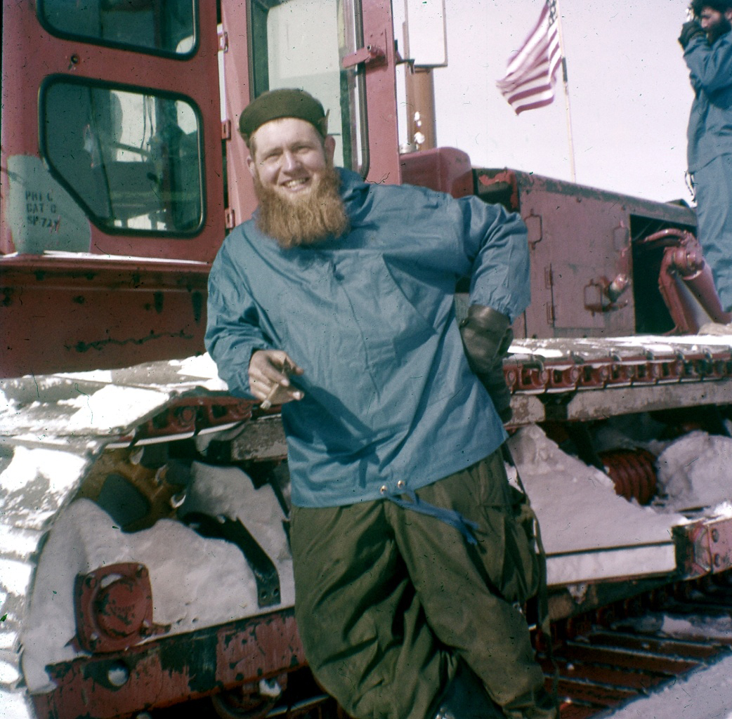 A man leaning on a tractor.