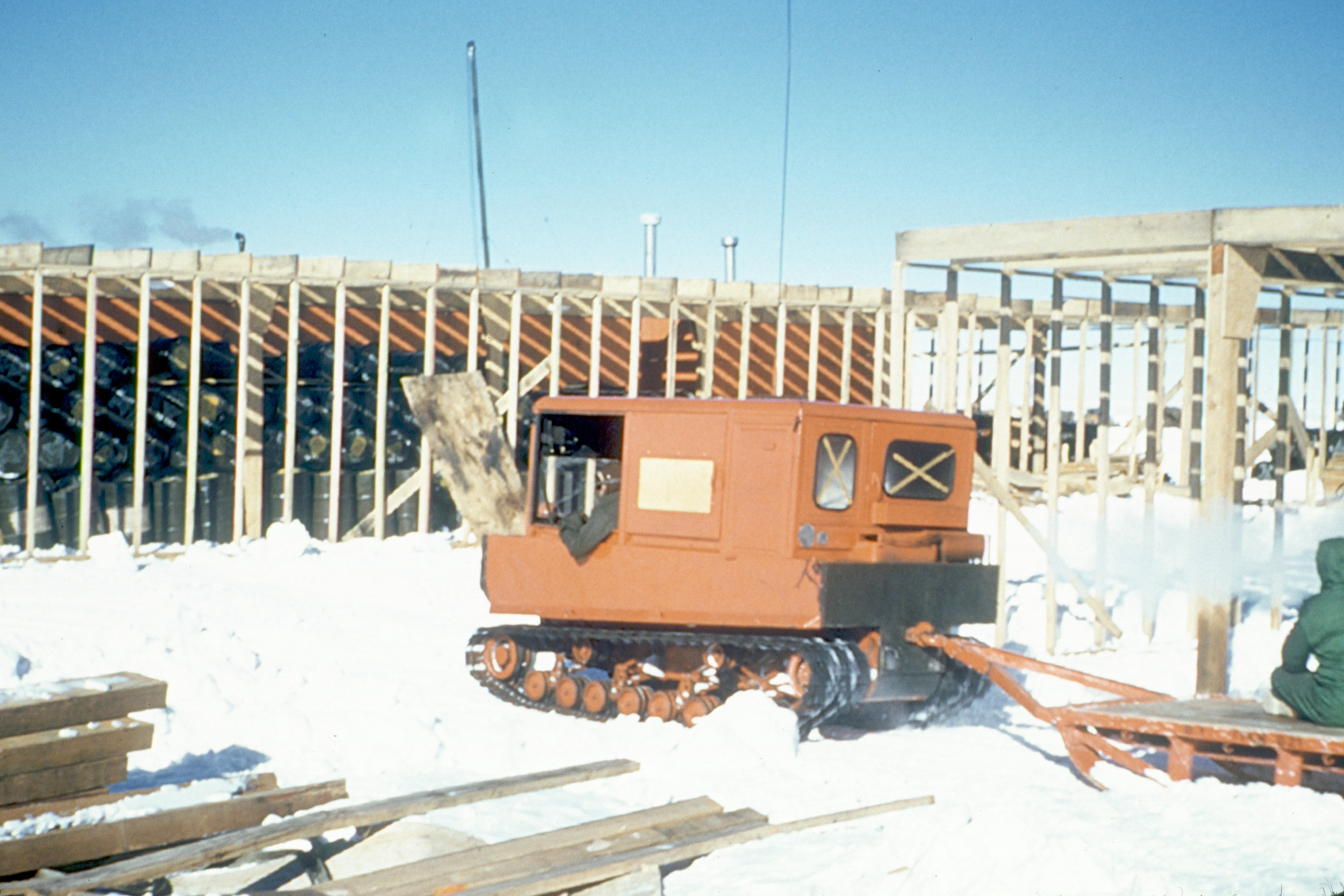 A tracked vehicle moves through construction area.