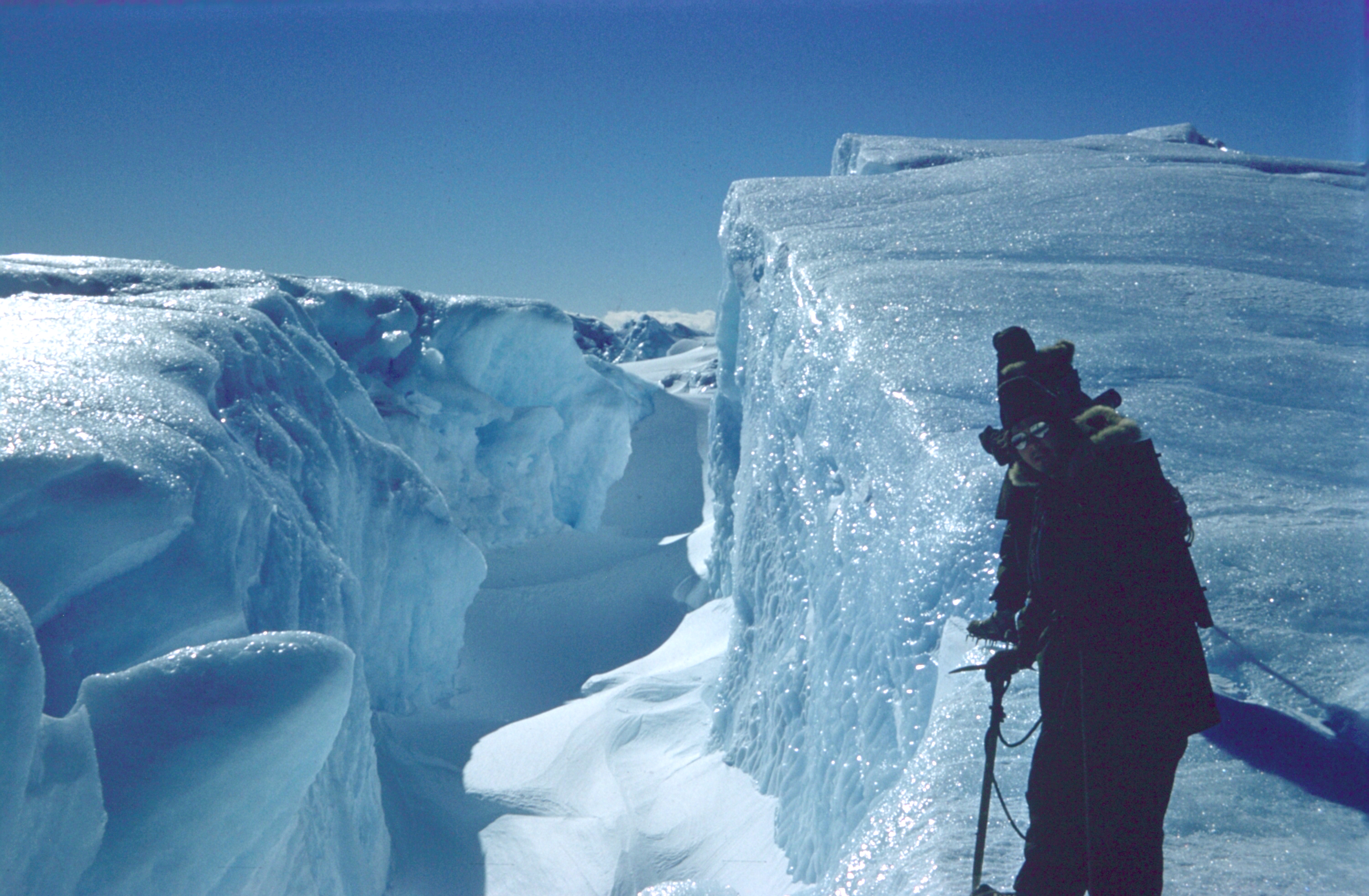 Man hikes on a glacier.