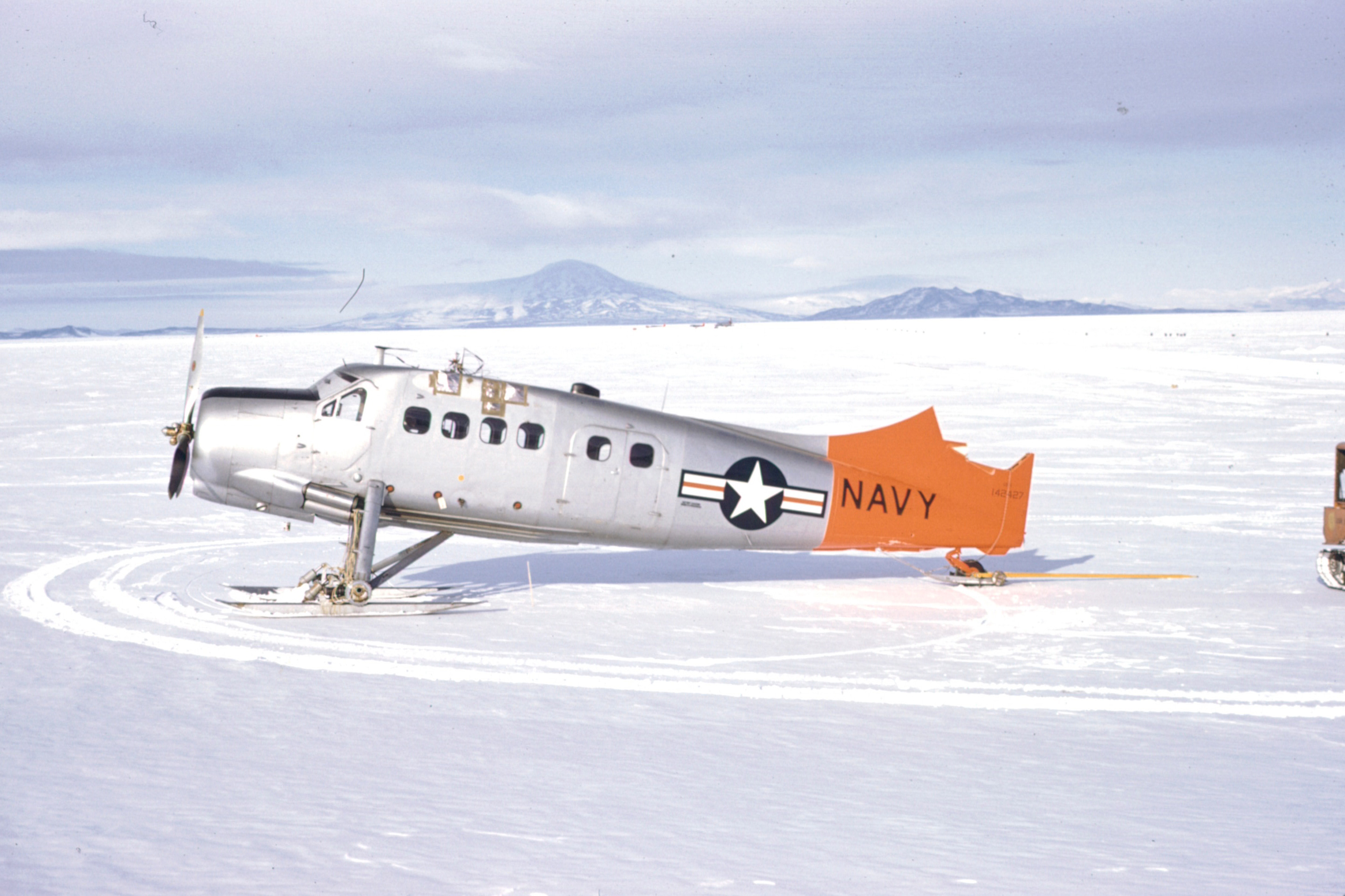 A wingless airplane sits on snow.