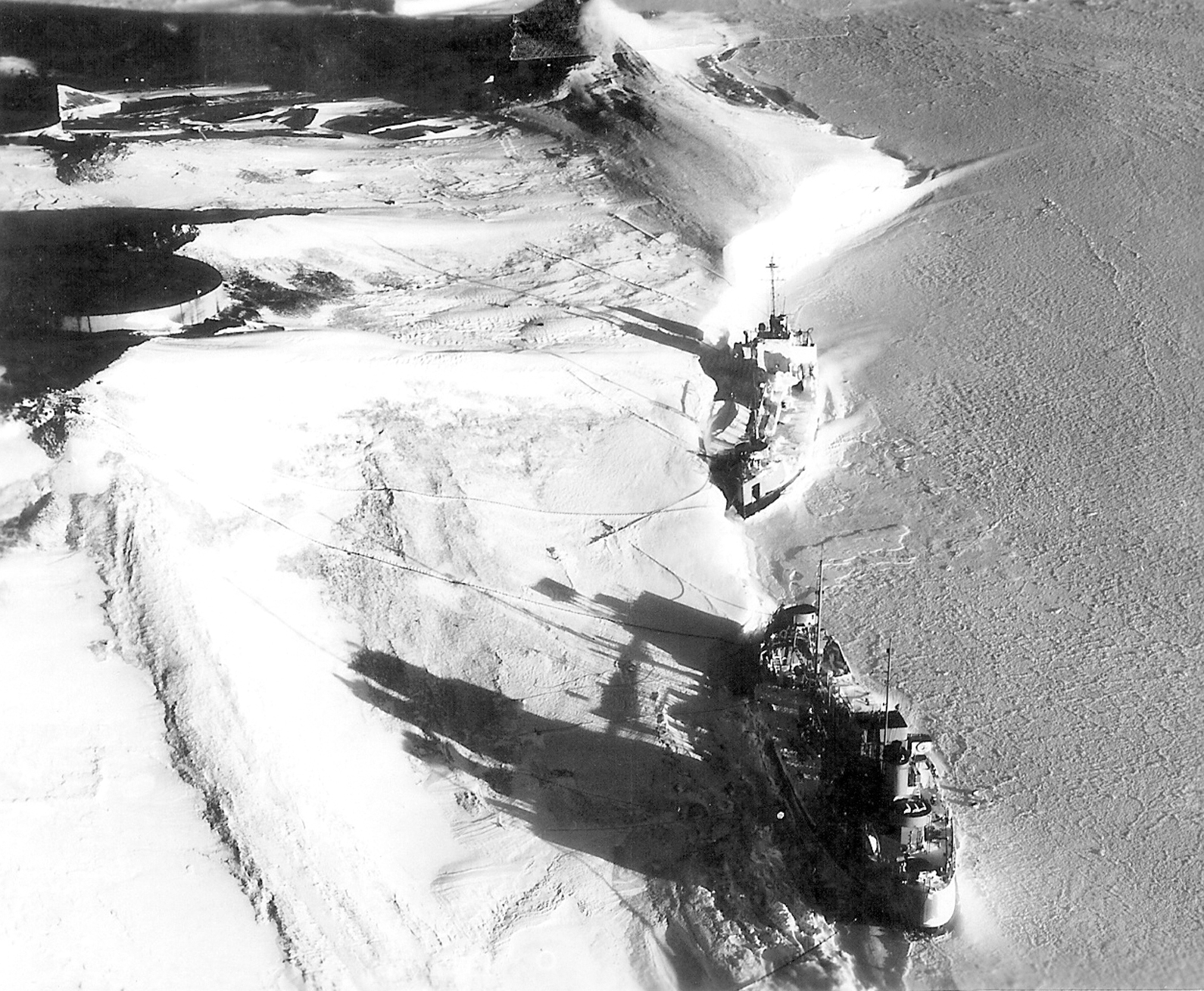 Aerial view of two ships frozen in ice.