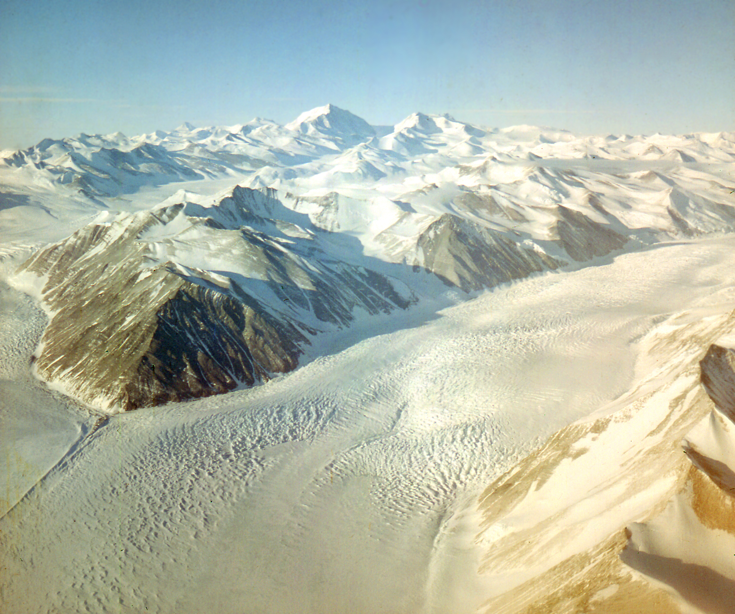 Aerial view of glacier and mountains.