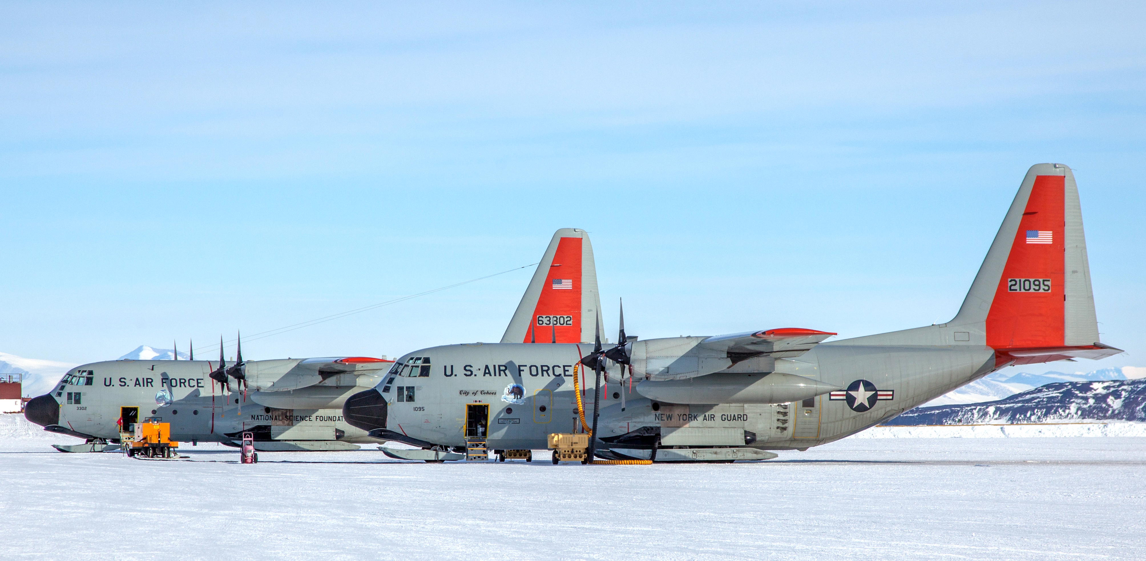 Two planes sit idle on the ice.