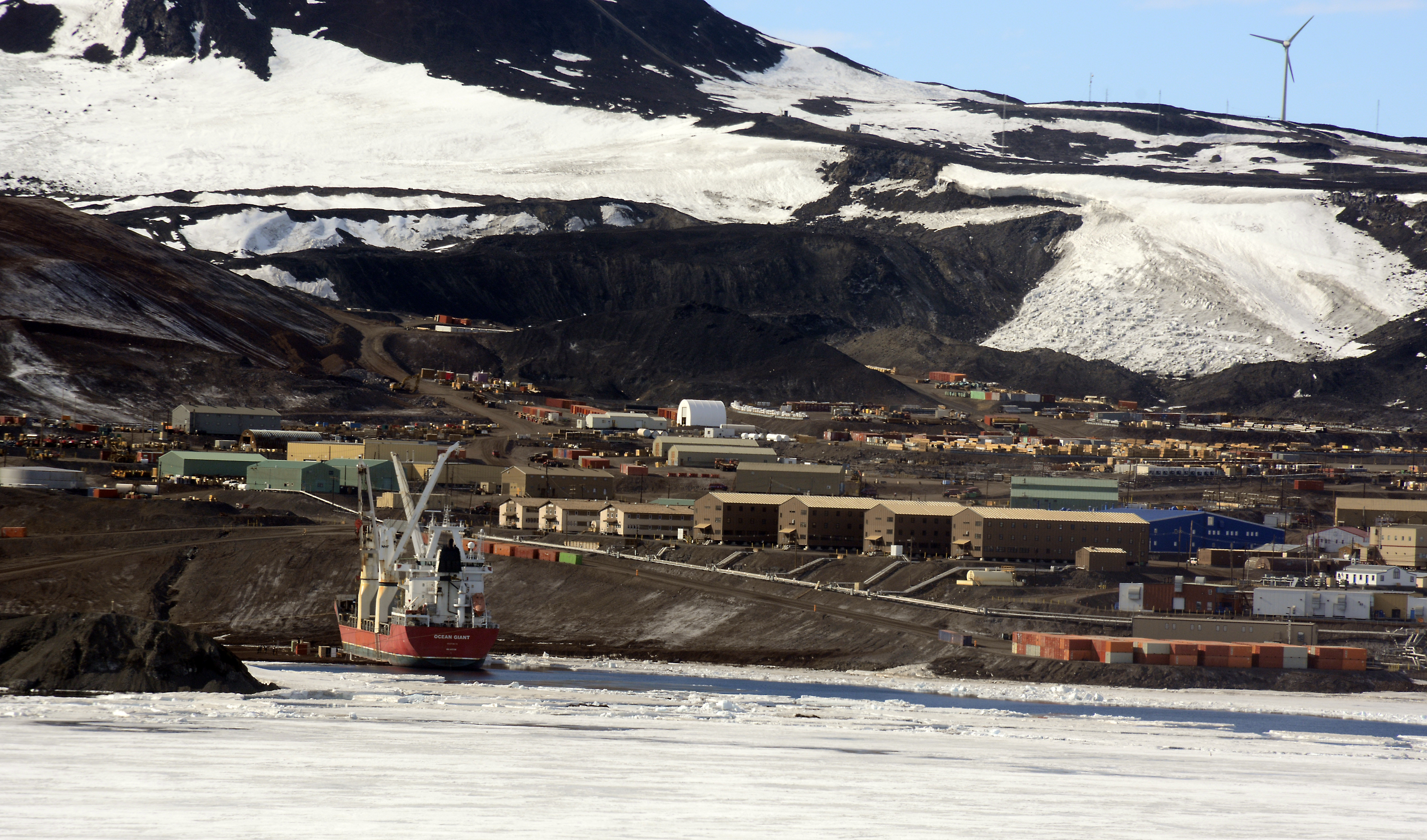 Ship is moored near a small town.