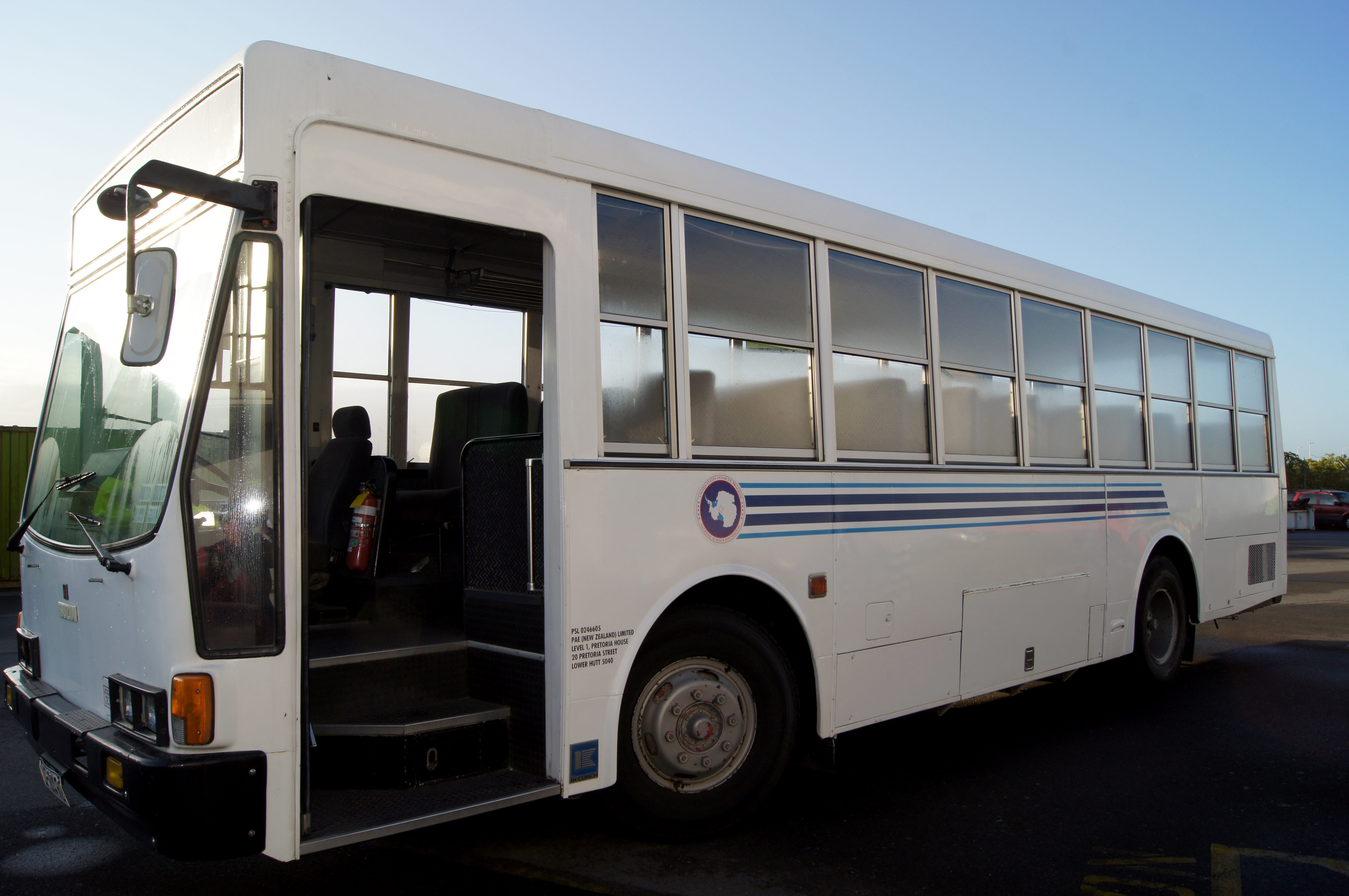 A white bus sits empty.