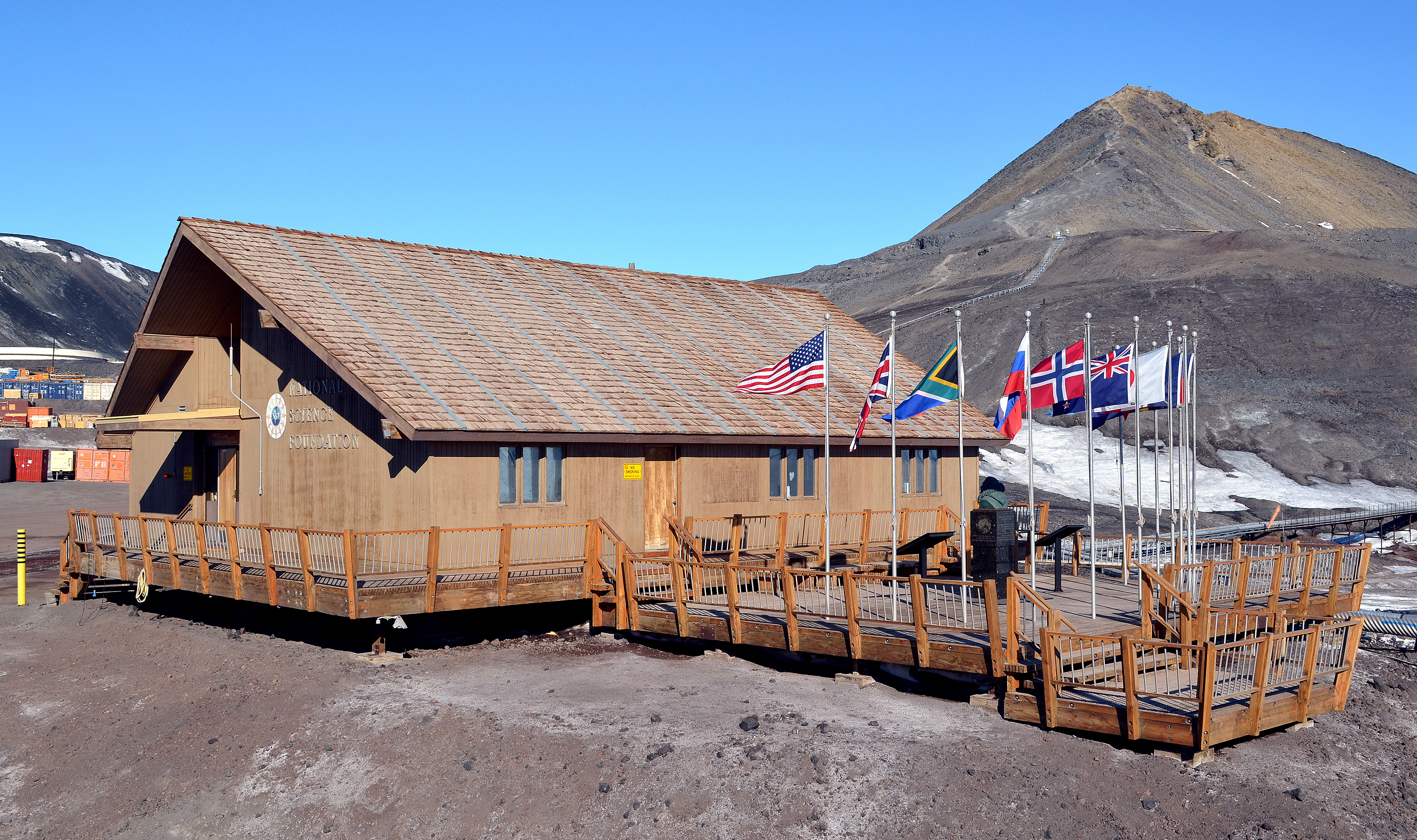 Small building in front of a hill. 