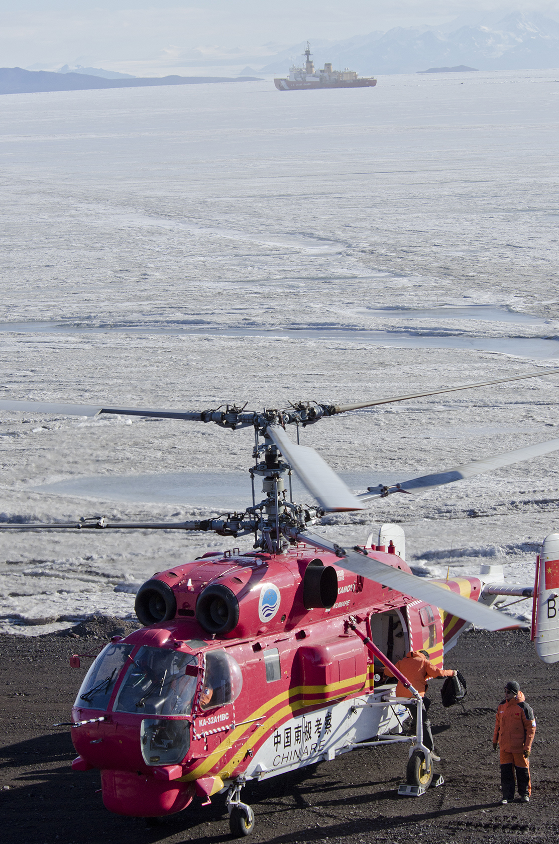 A helicopter near the ice-covered ocean.