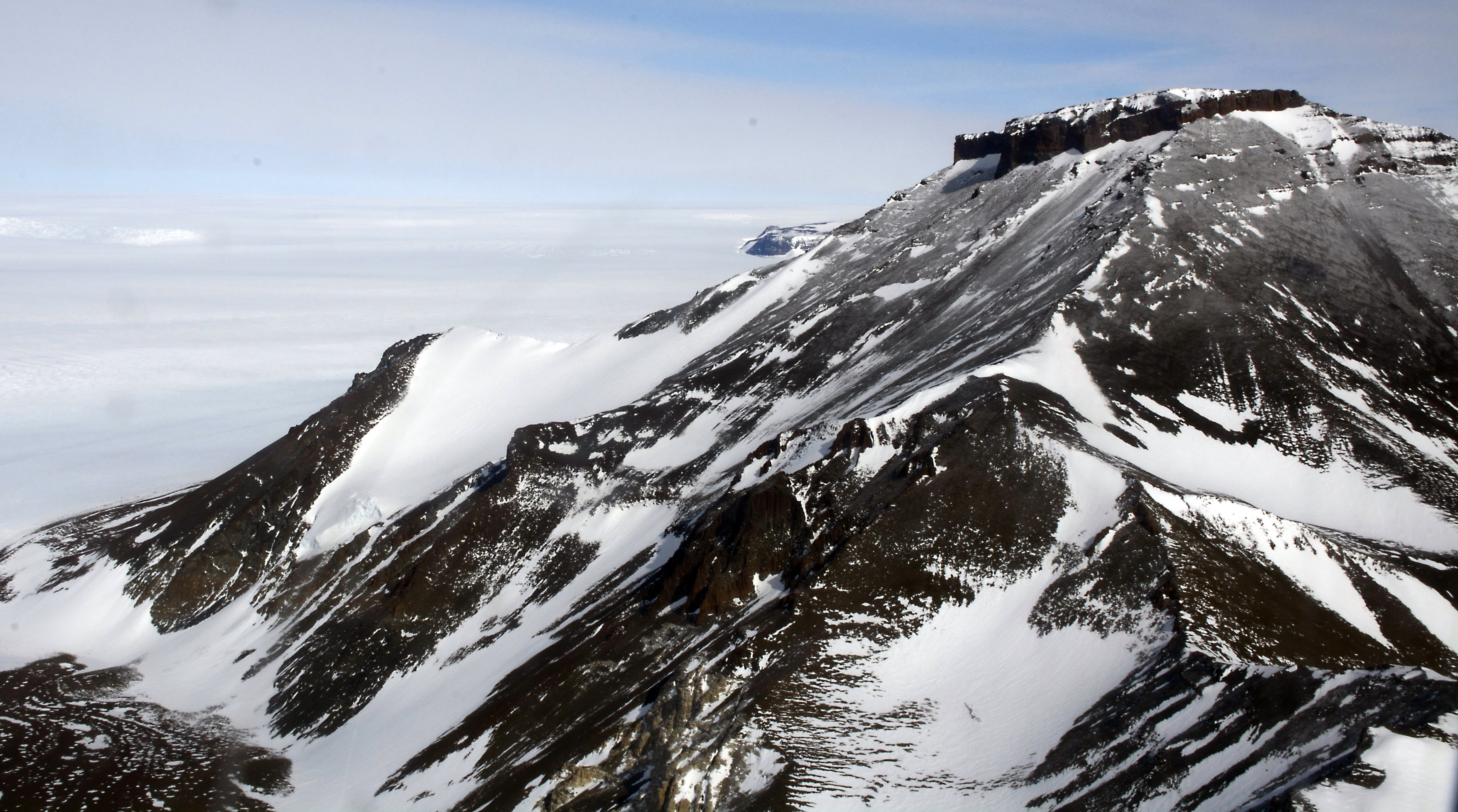 Aerial view of glaciated mountain range.