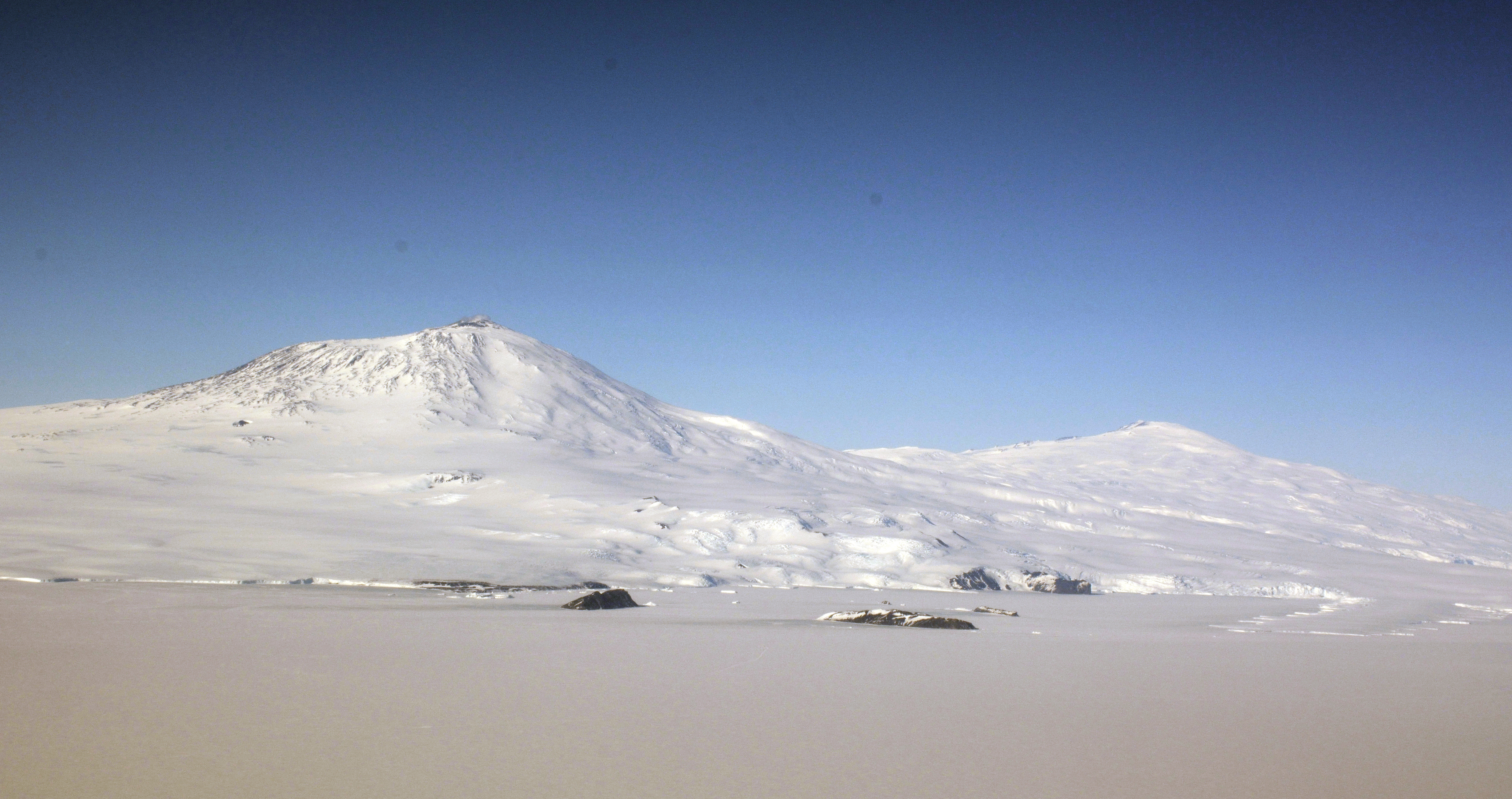 Snow covers two mountains.