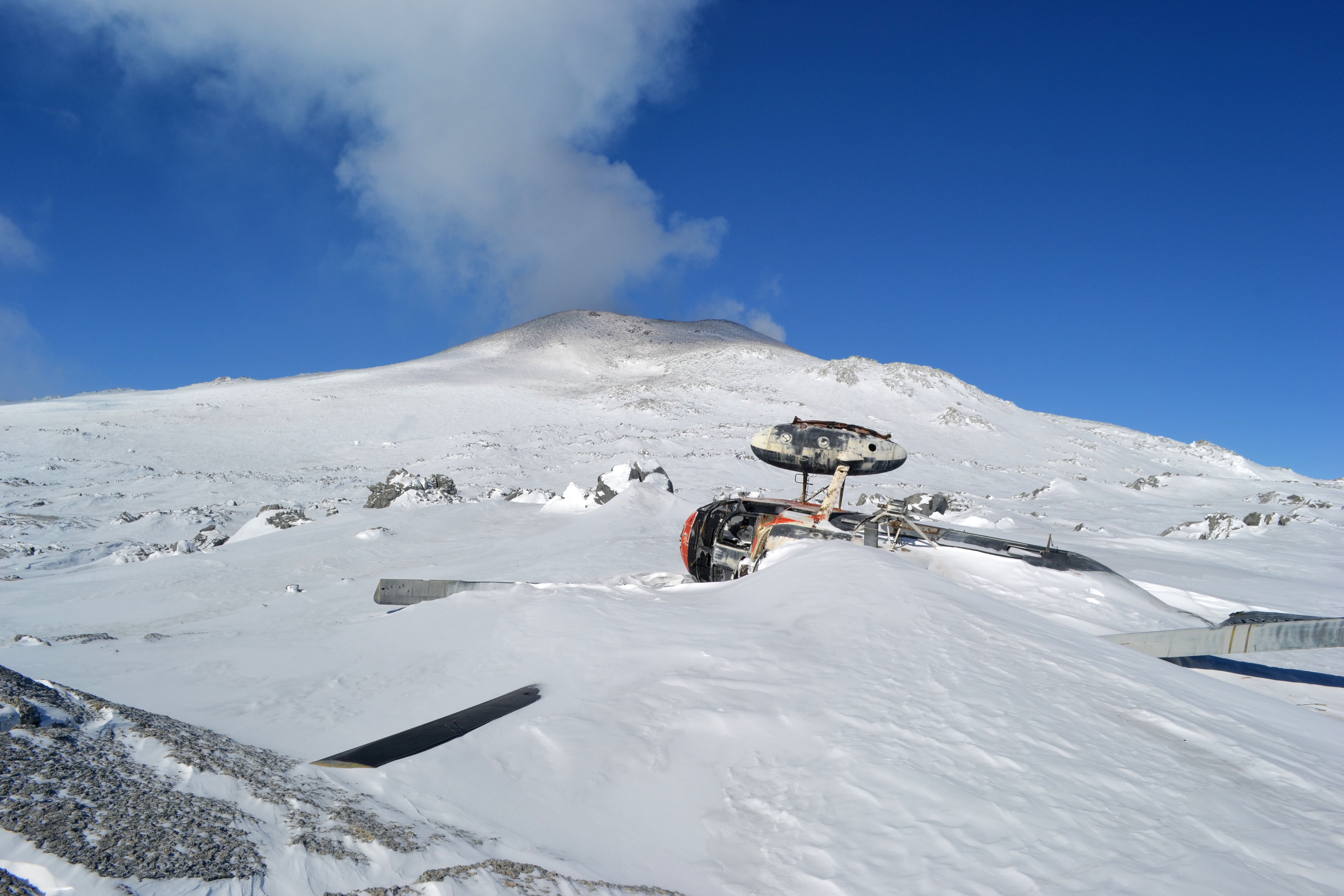 Helicopter debris covered with snow.