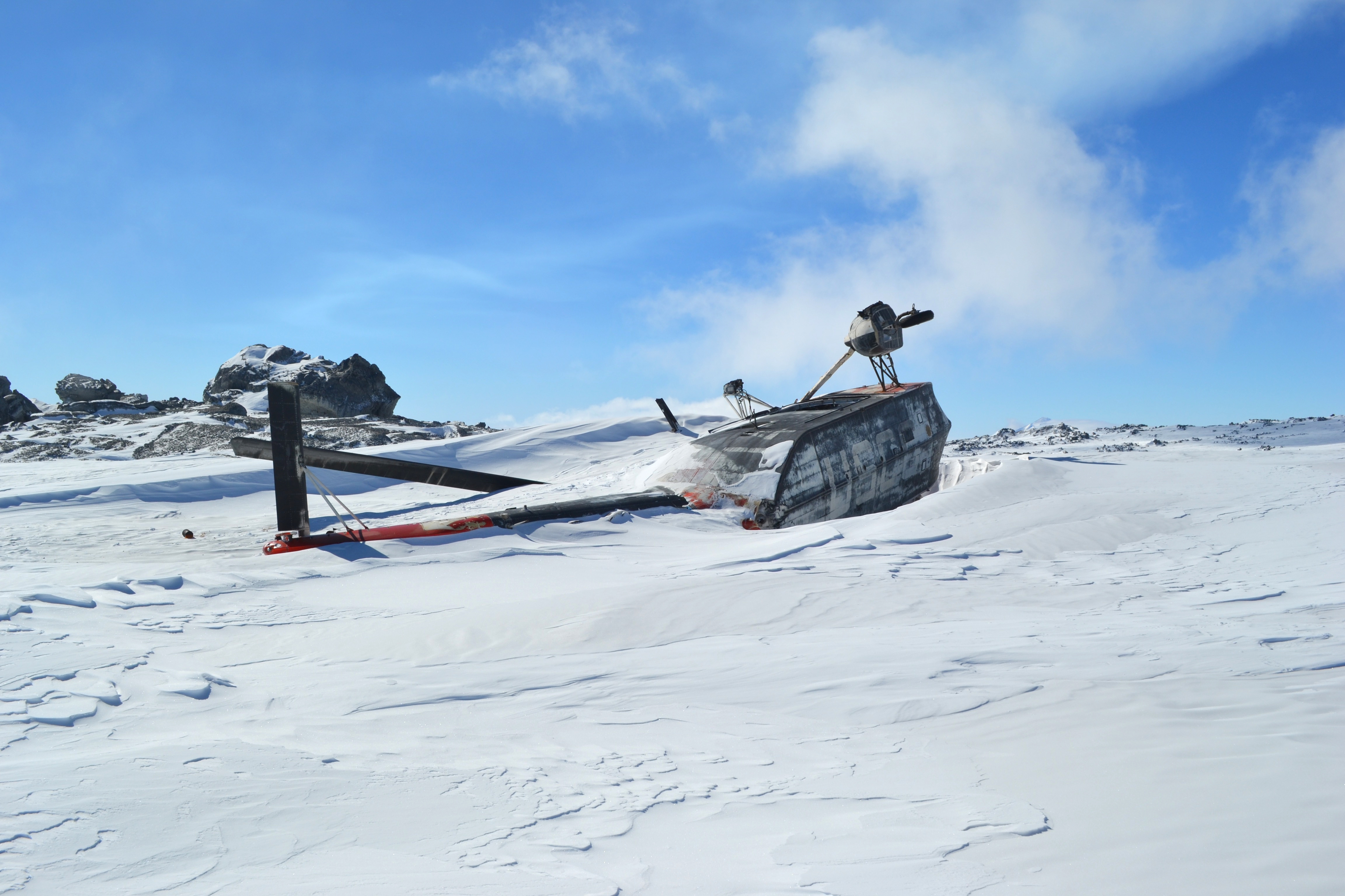 Helicopter debris covered with snow.