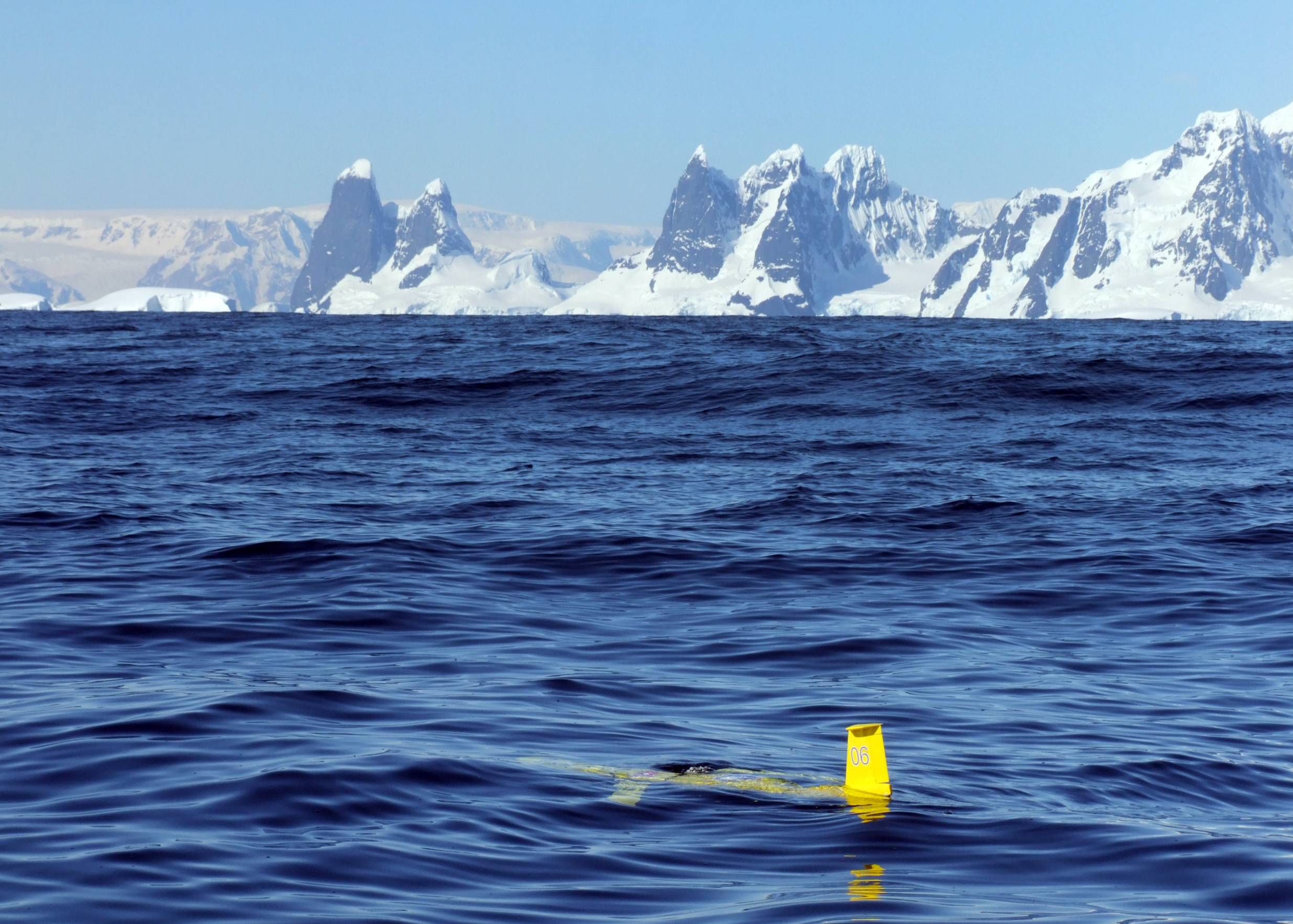 Yellow sub glides along water surface.