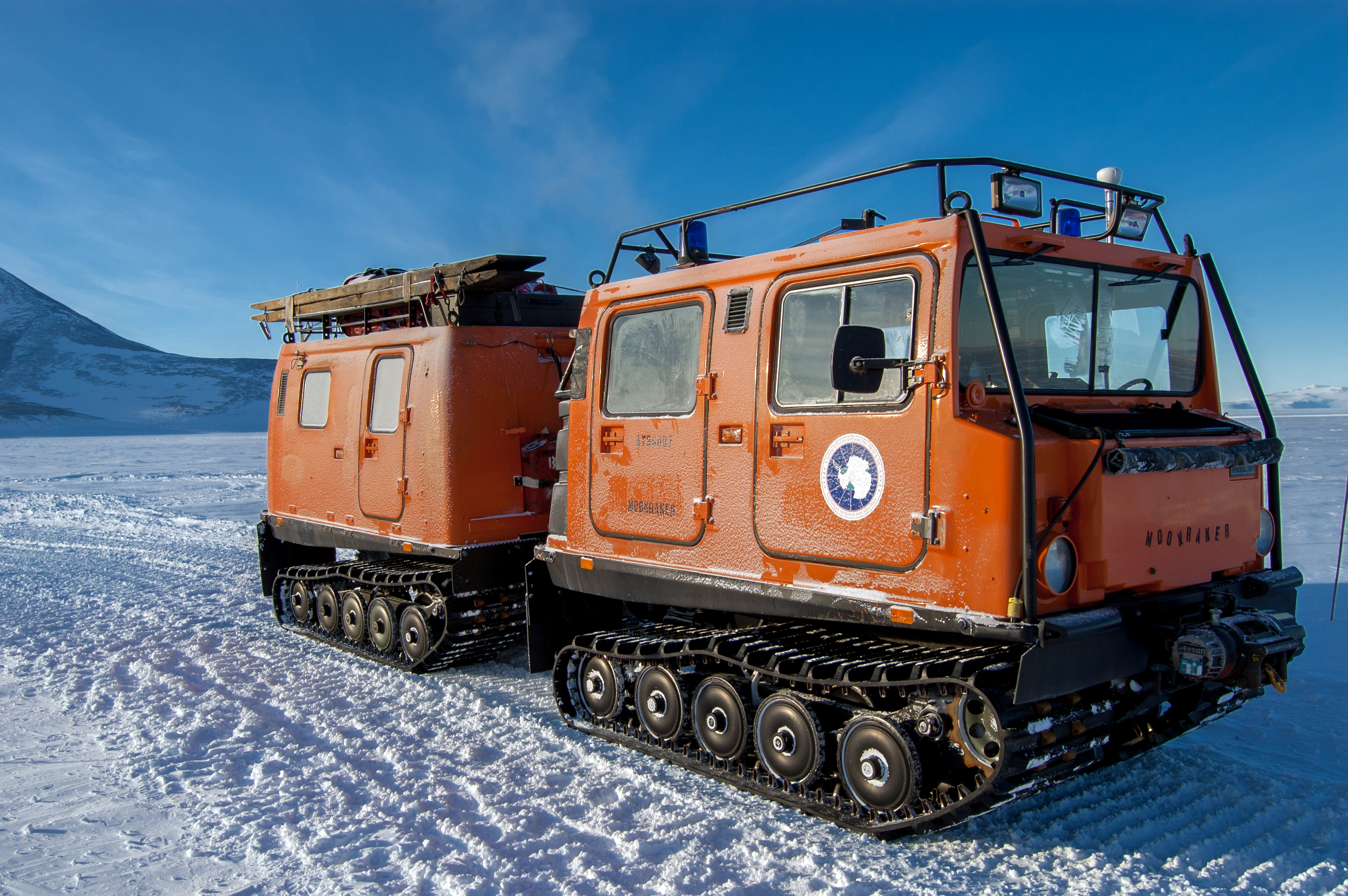 A tracked vehicle stands still on ice.