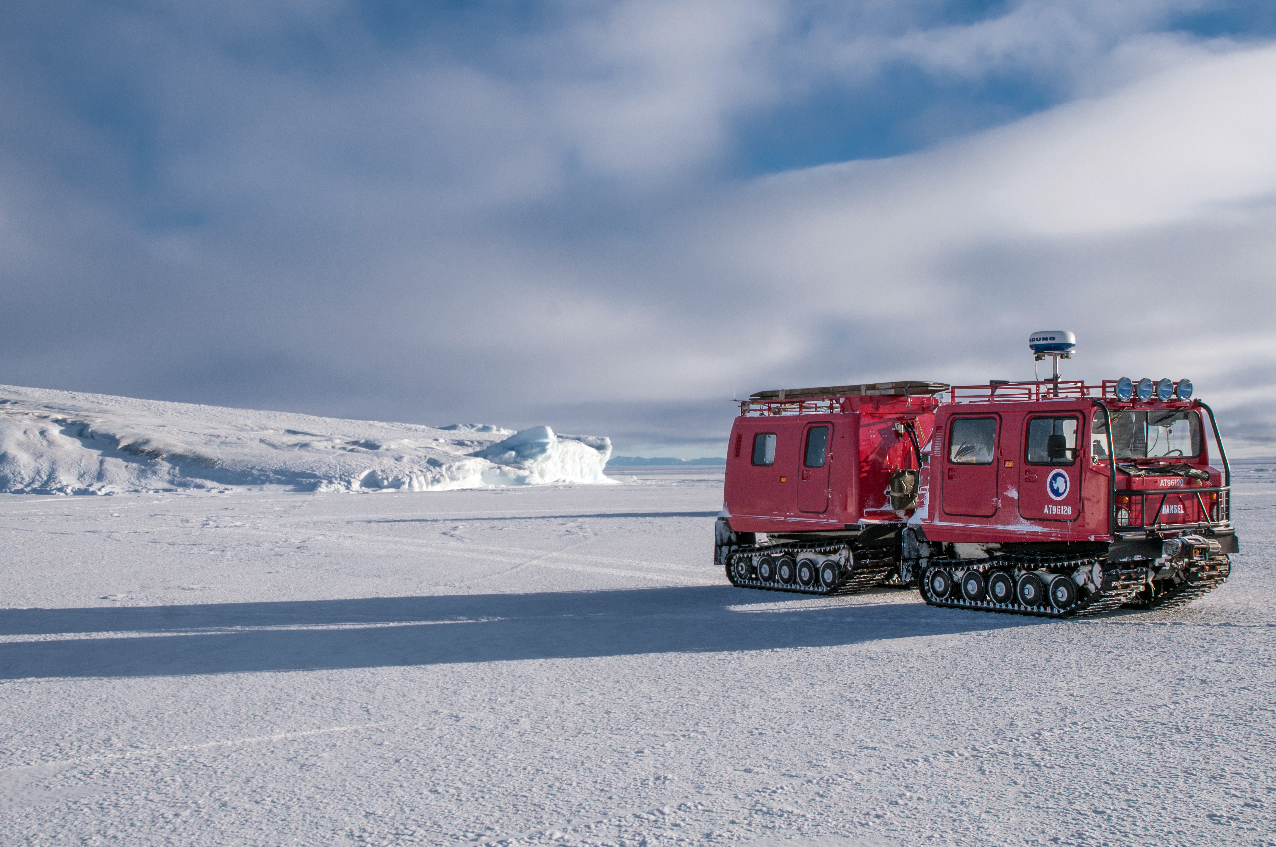 A tracked vehicle stands still on ice.