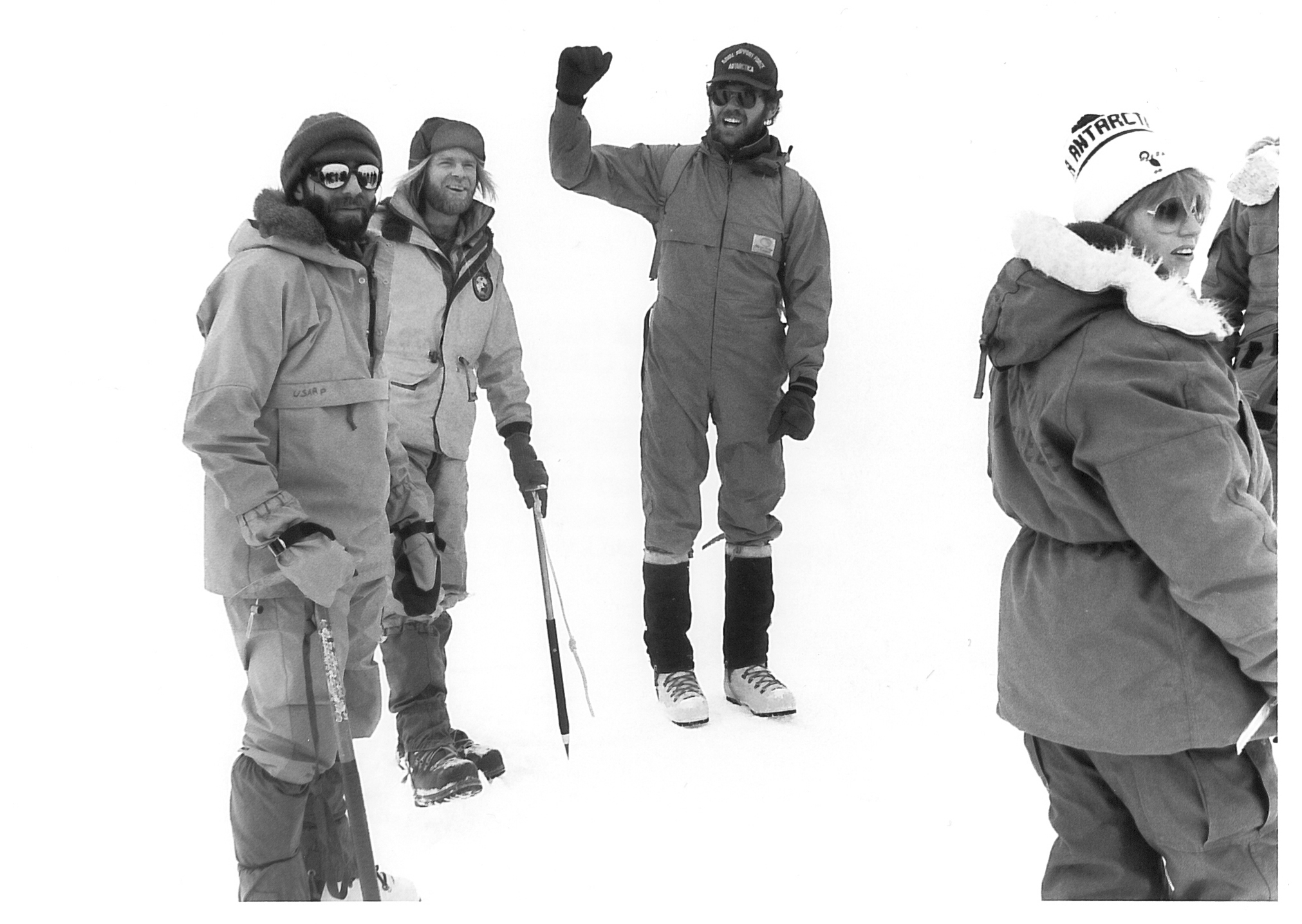 Several people standing and talking outside in the snow.