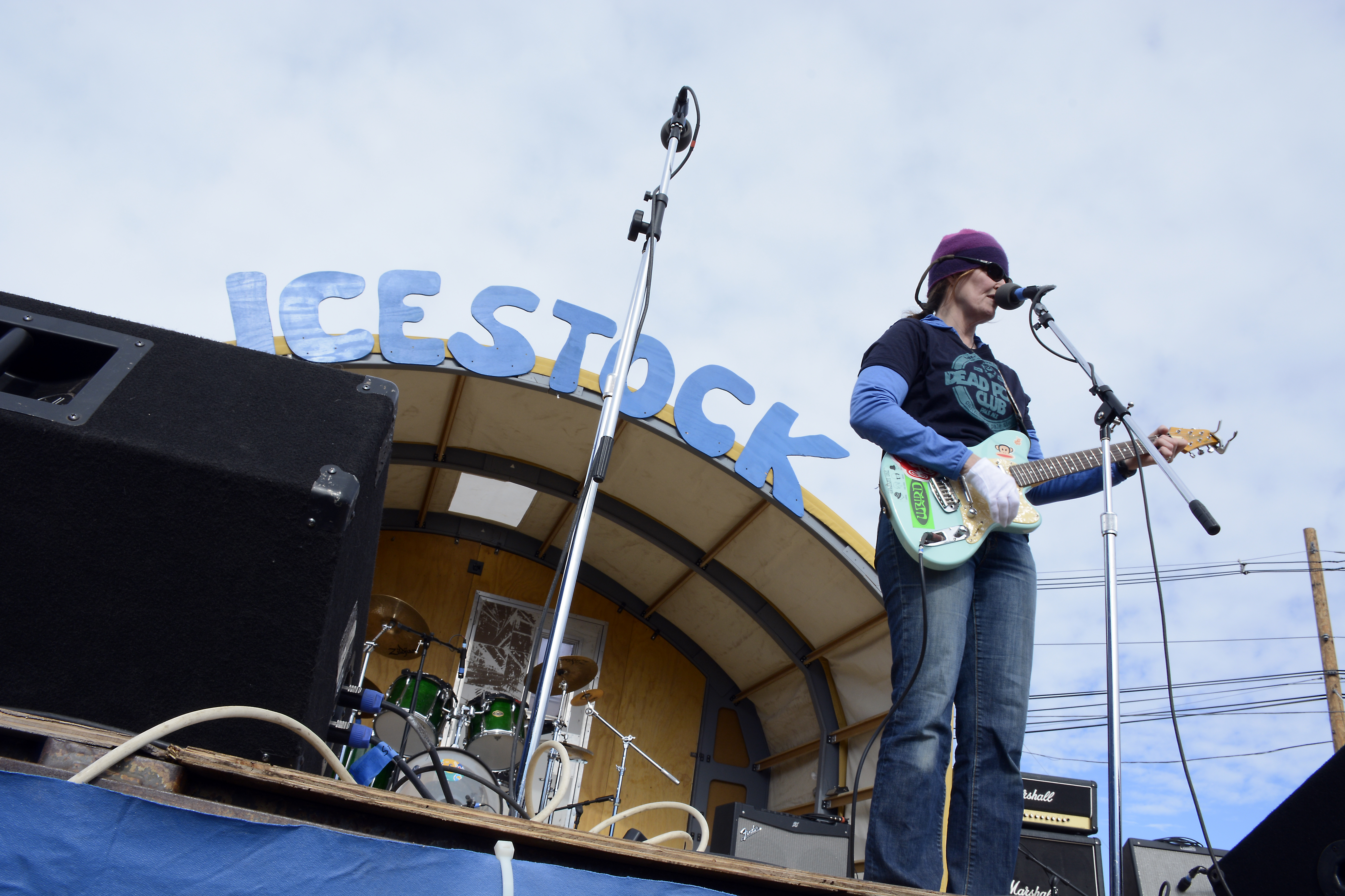 Person plays guitar on stage.