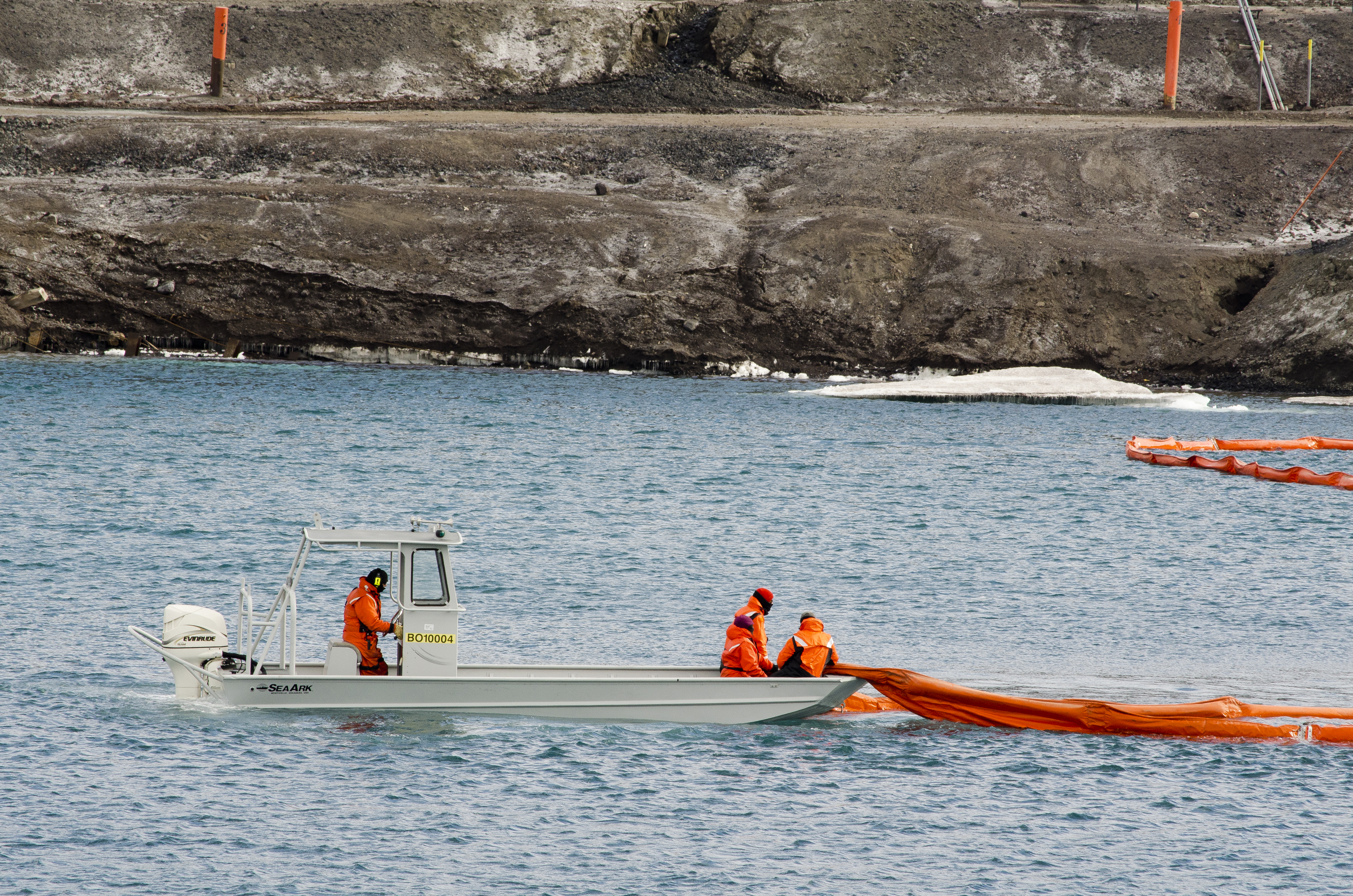 Small boat moves line around in water.