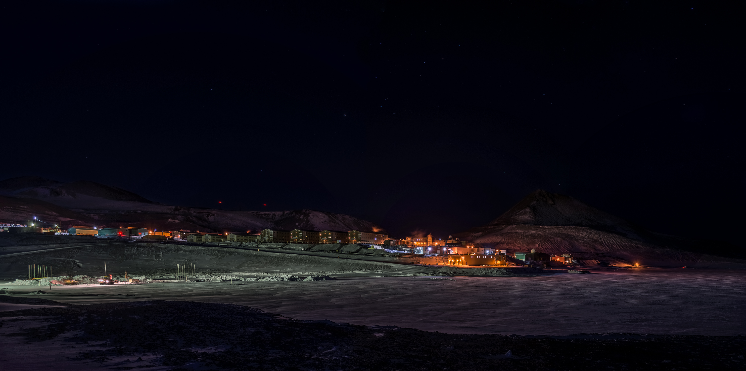 A small town is lit up at night.