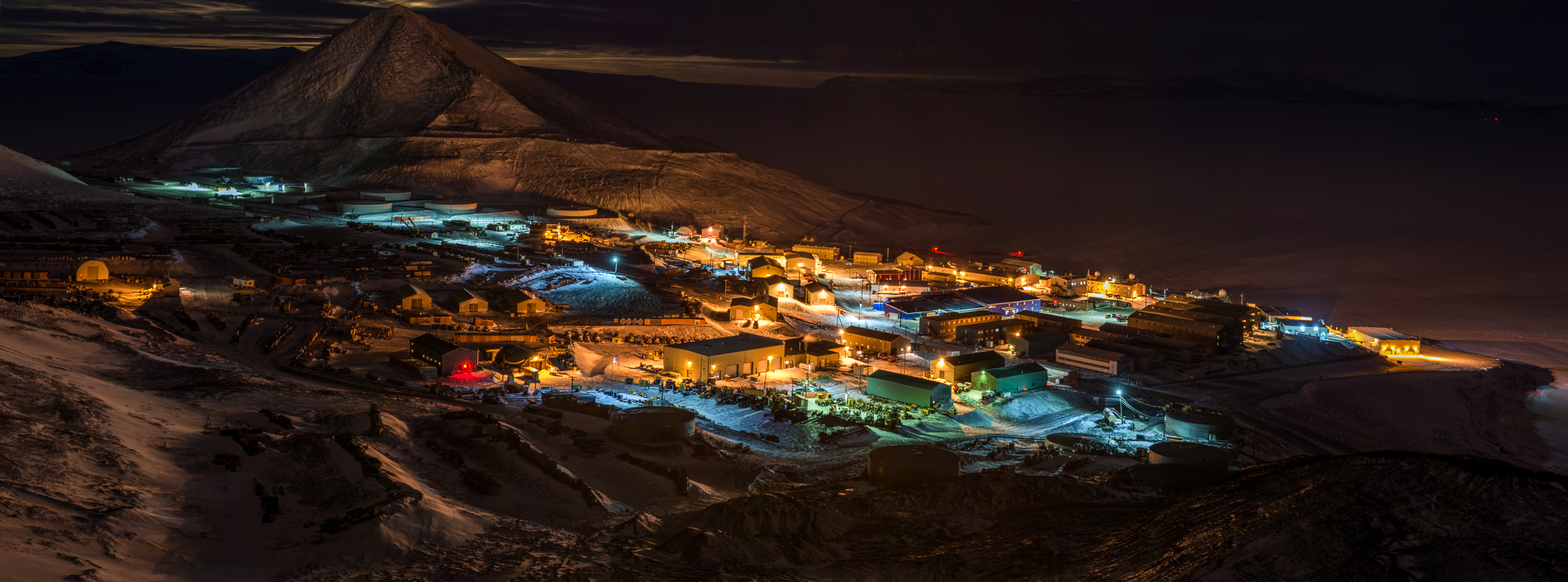 A small town is lit up at night.