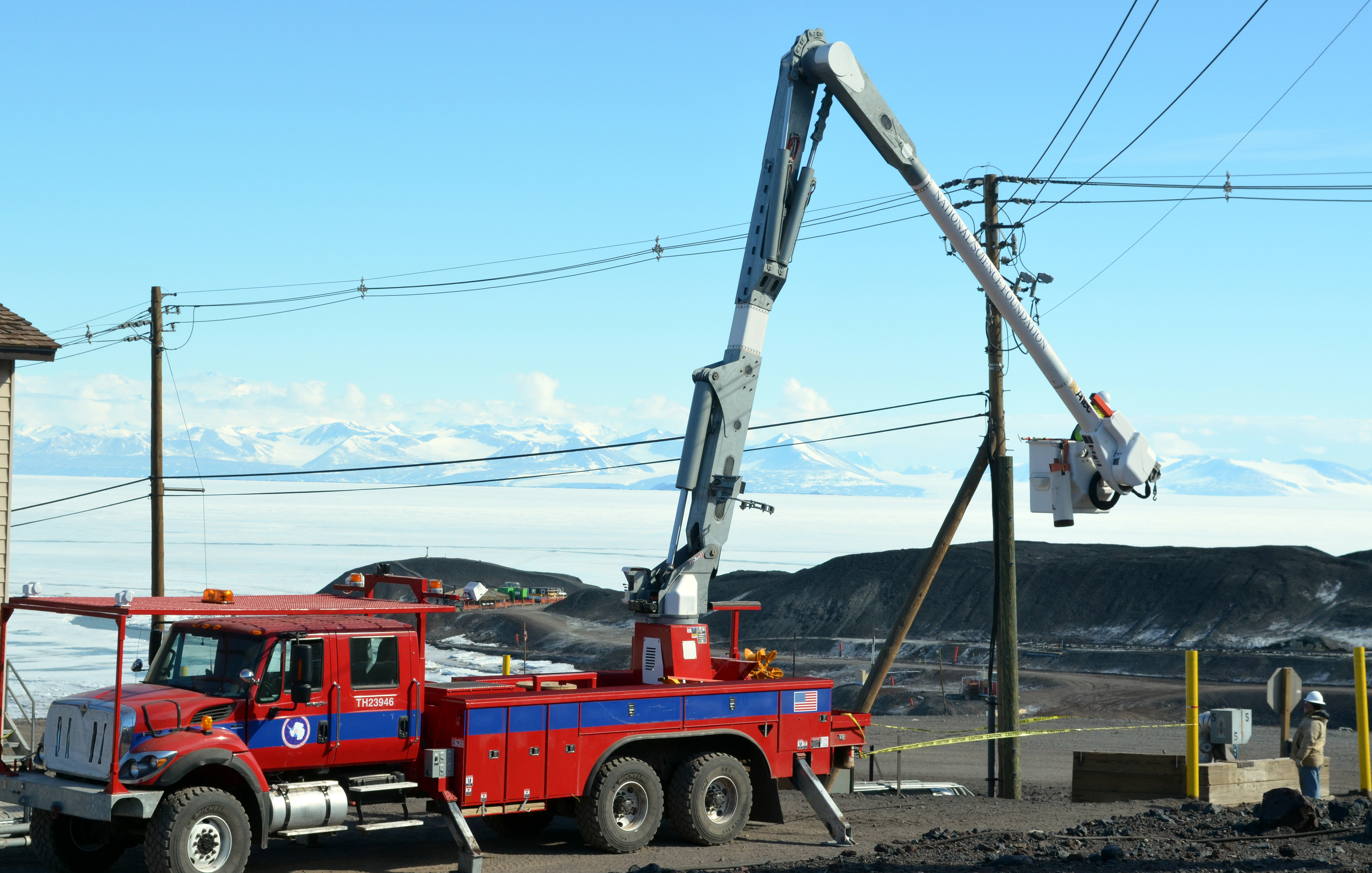 Bucket truck parked near power line.