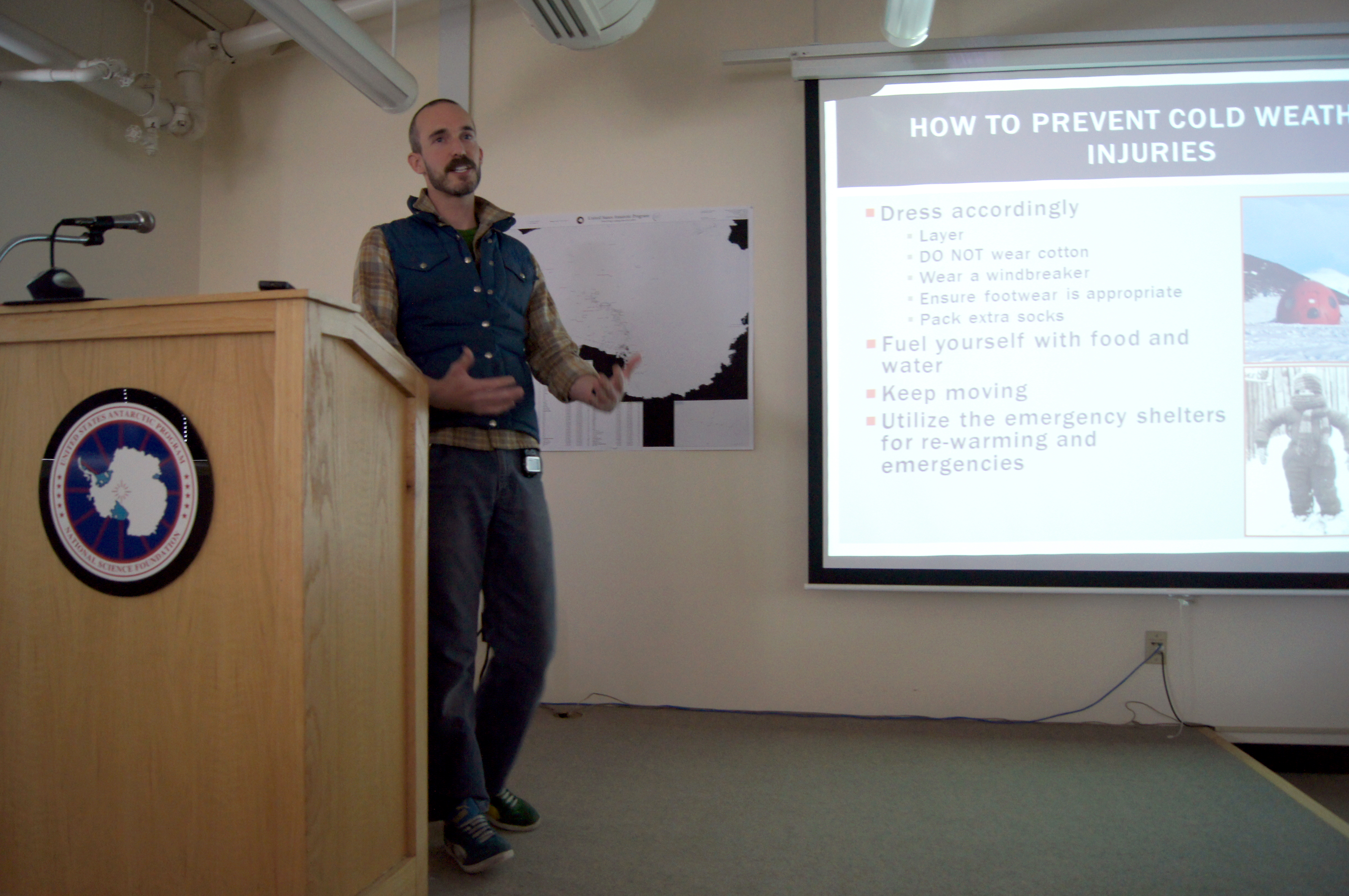 A man speaking from behind a lectern.