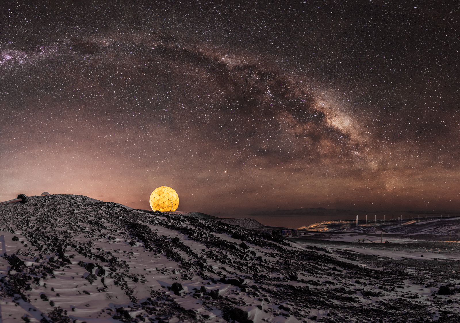 A photo of the Milky Way with a lighted dome.