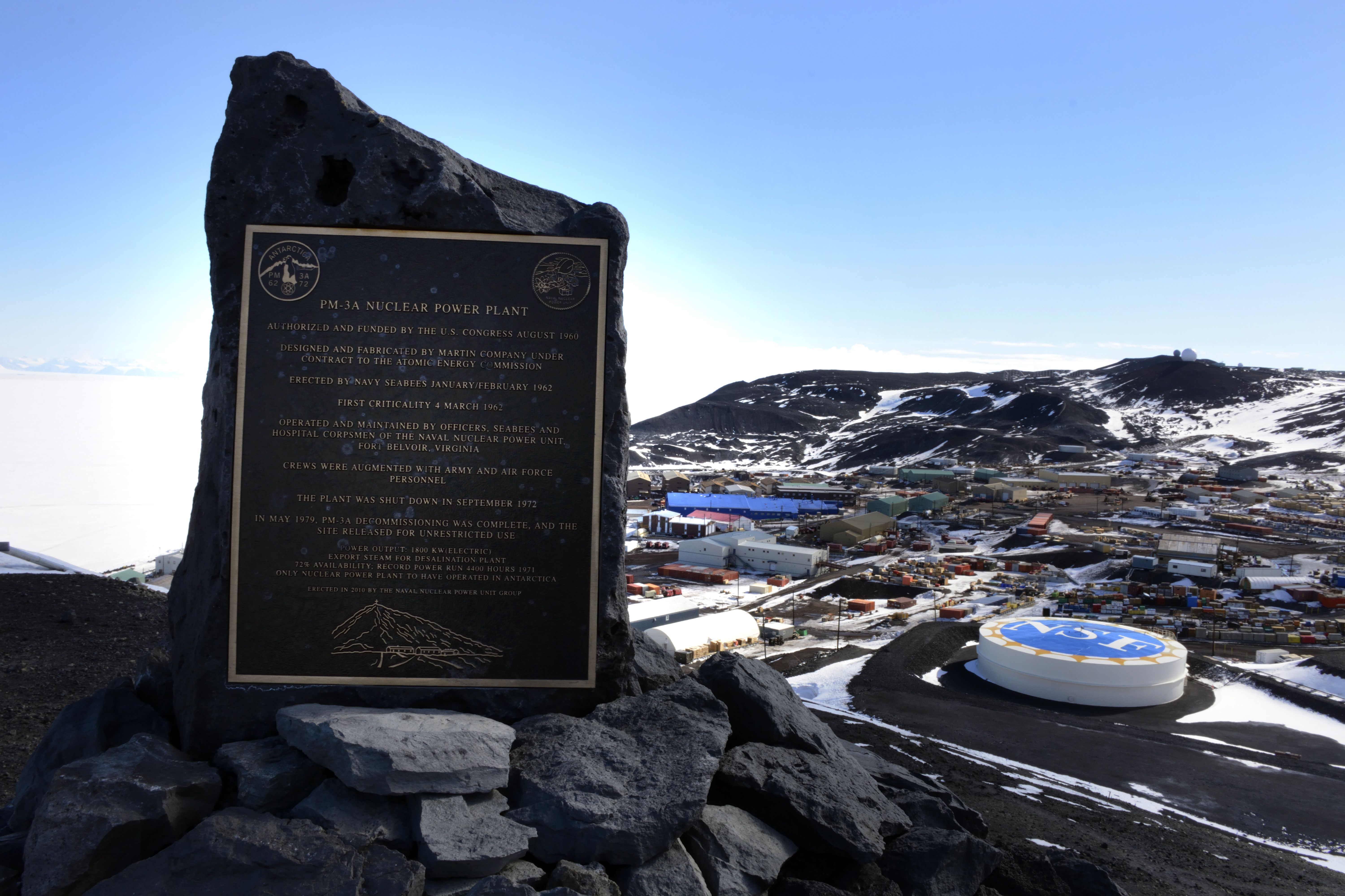 Plaque sits above a small town.