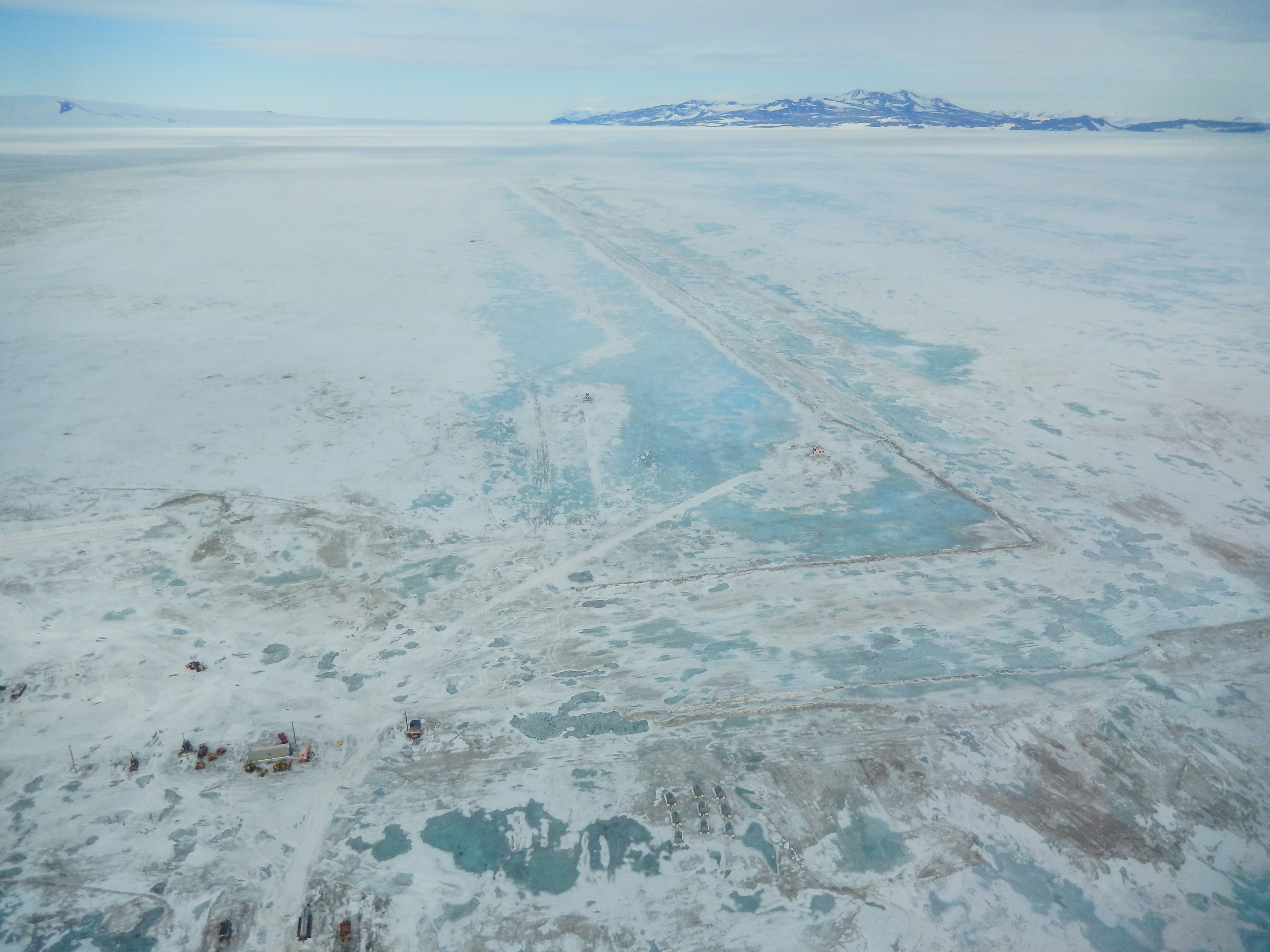 Aerial photo of melting ice and buildings.
