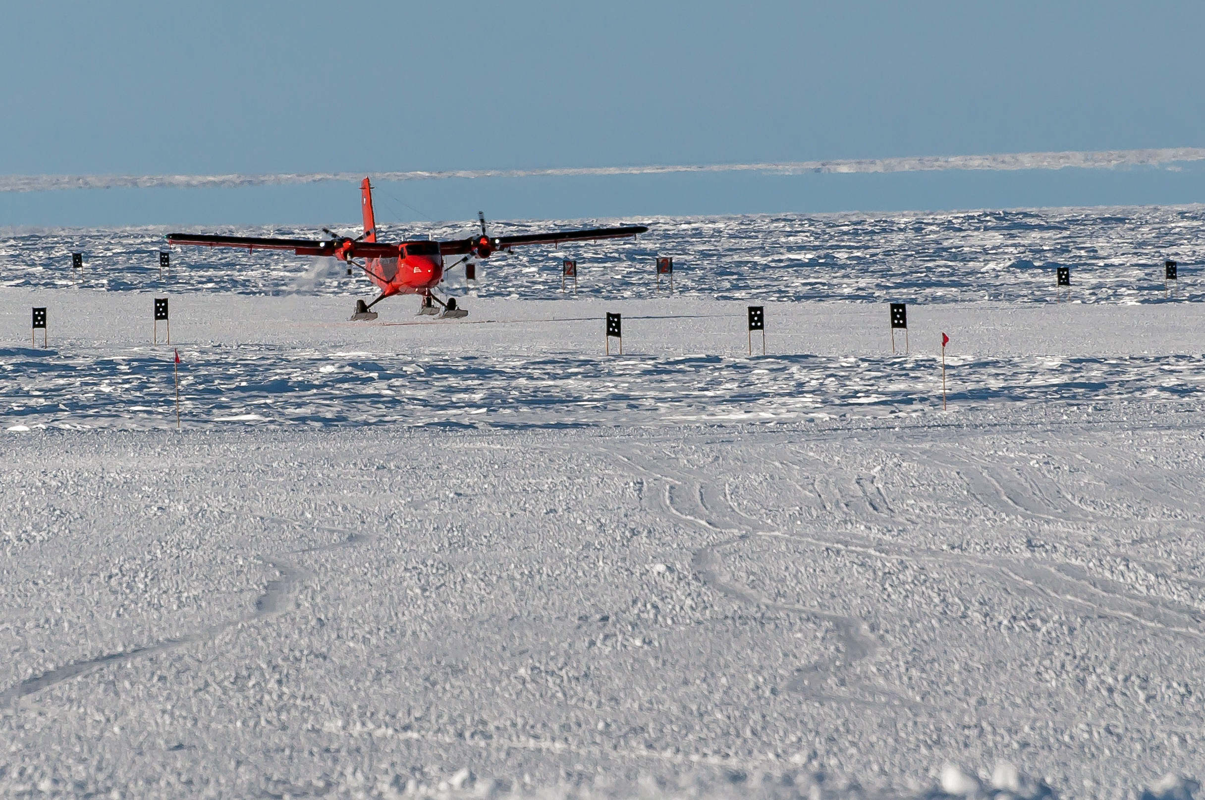 Plane takes off from ice field.