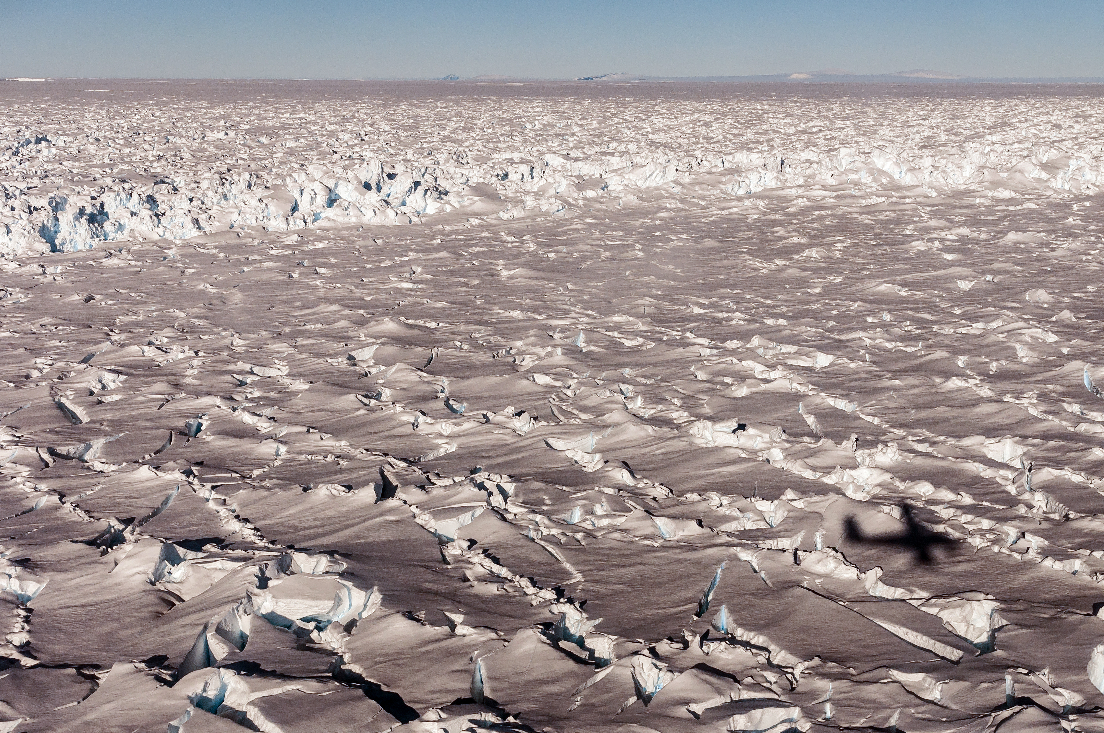 Heavily crevassed surface of snow.