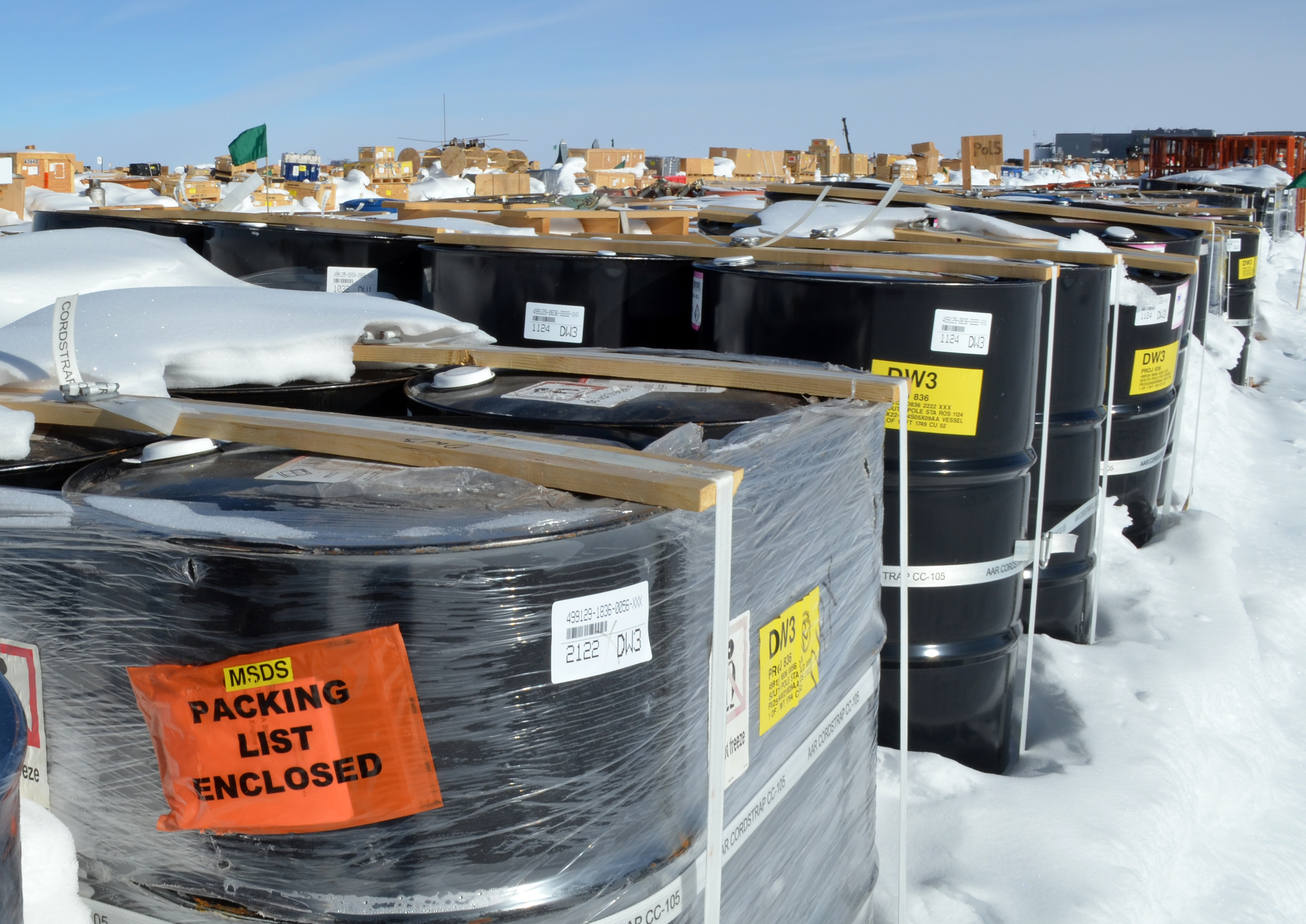 Pallets of cargo sit in snow.