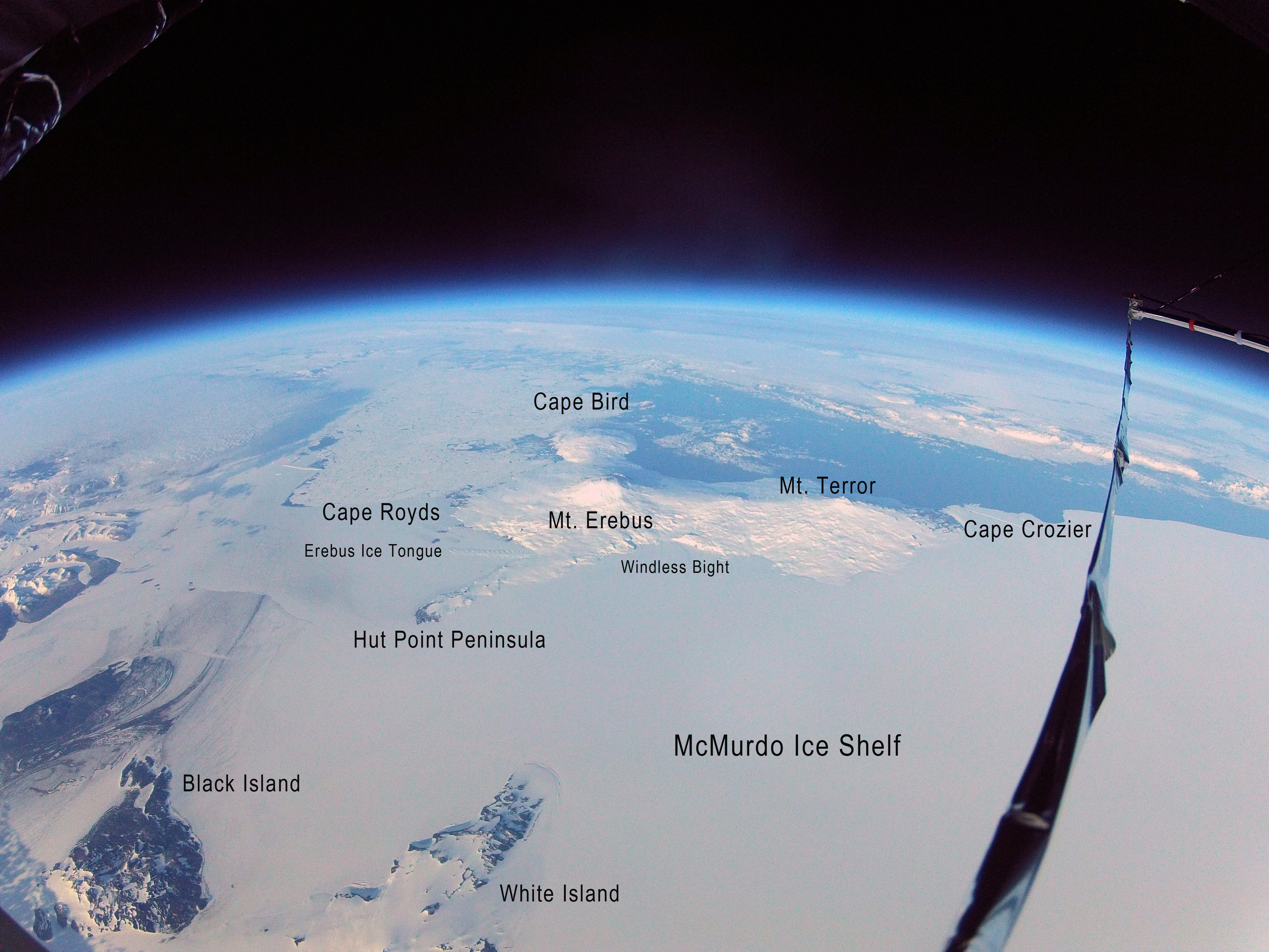 Space view of ice covered Earth with locations labeled on the photo.