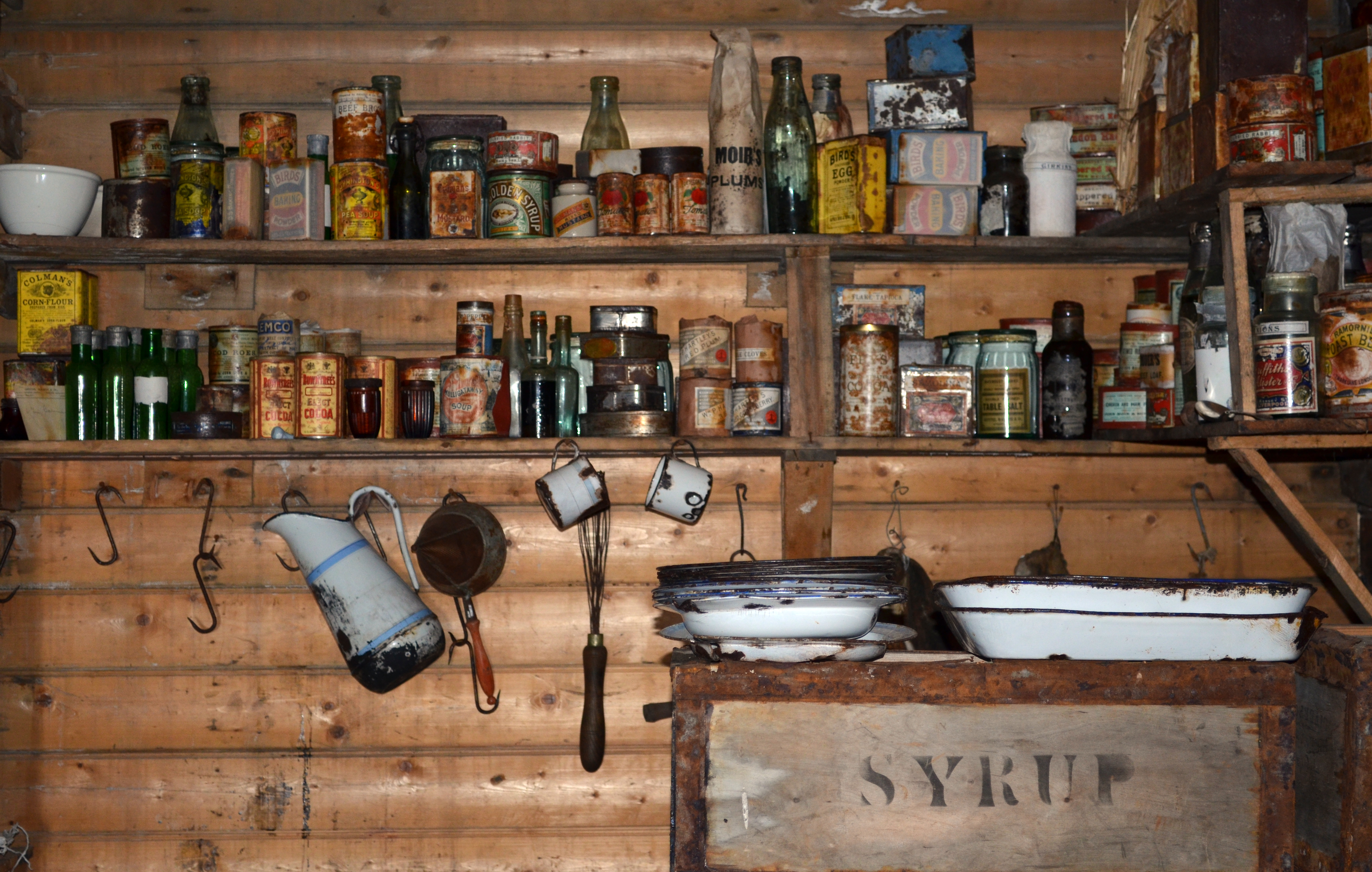 Condiments sit on a shelf.