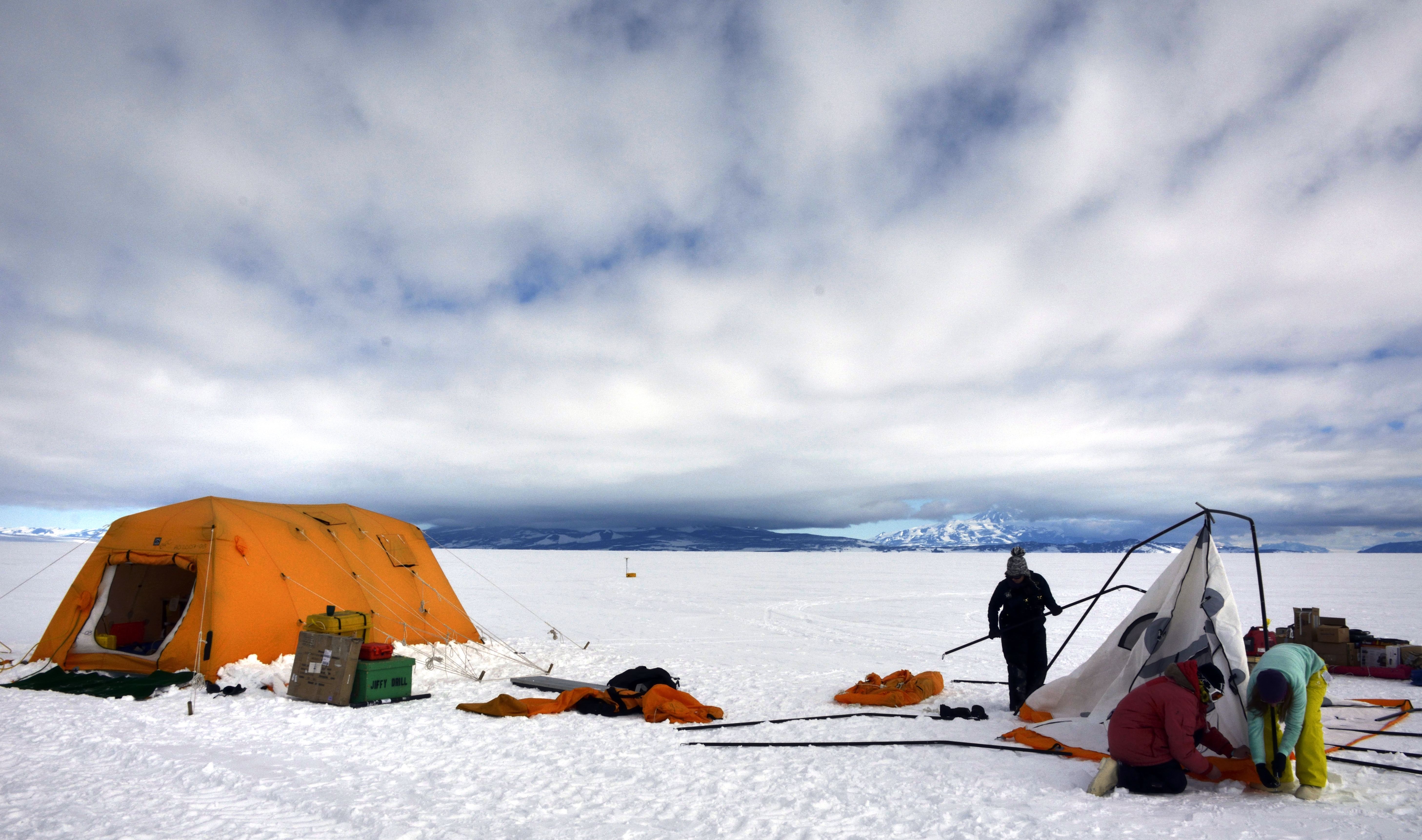 People set up a tent.