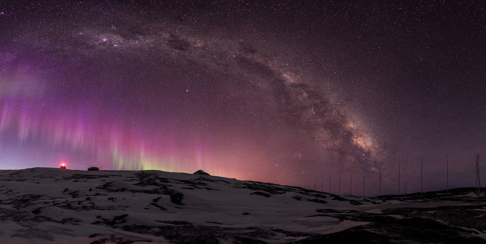 Auroras and the Milky Way over antennas.