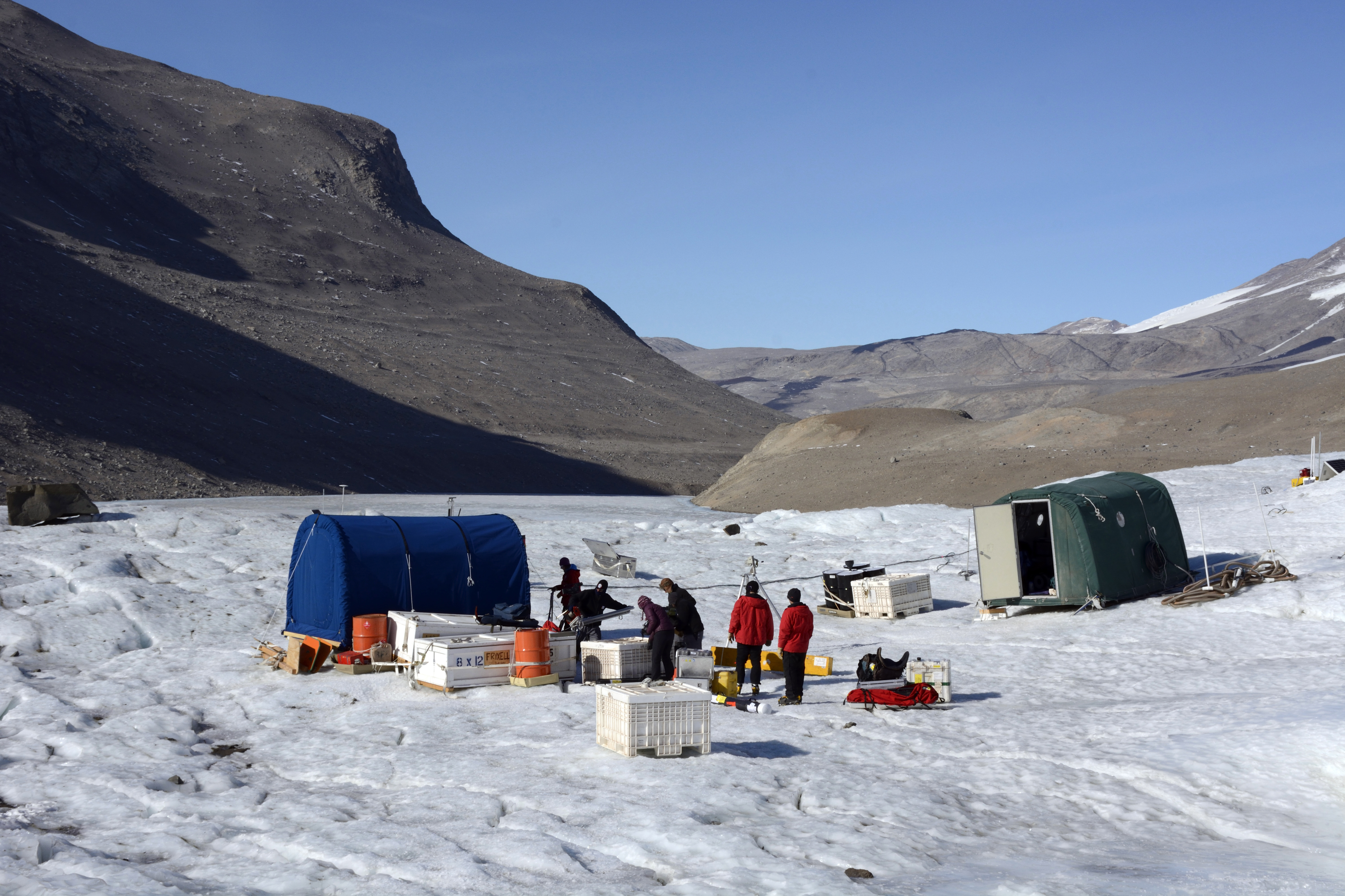 People work from a small camp.